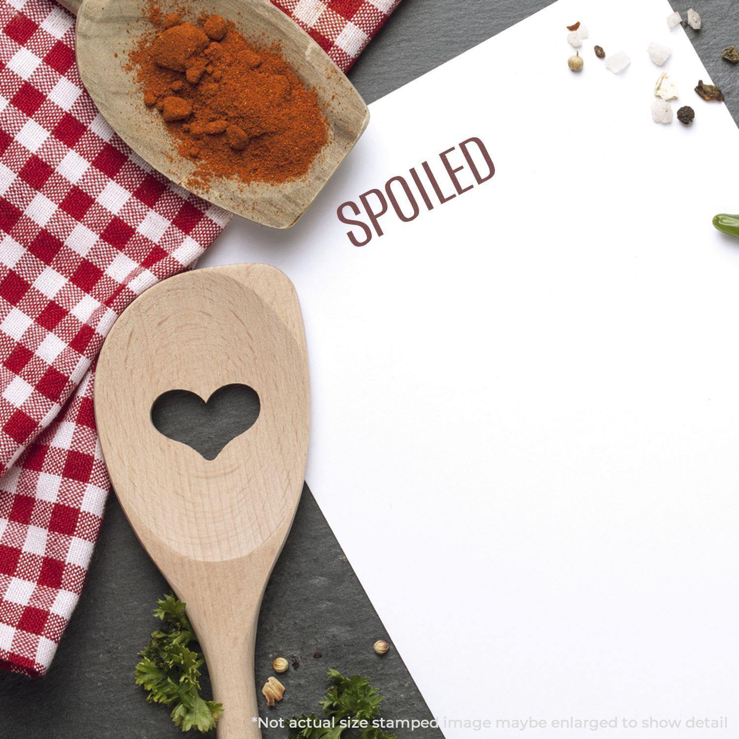 Large Pre-Inked Spoiled Stamp used on paper, with a wooden spoon, spices, and a red checkered cloth in the background.