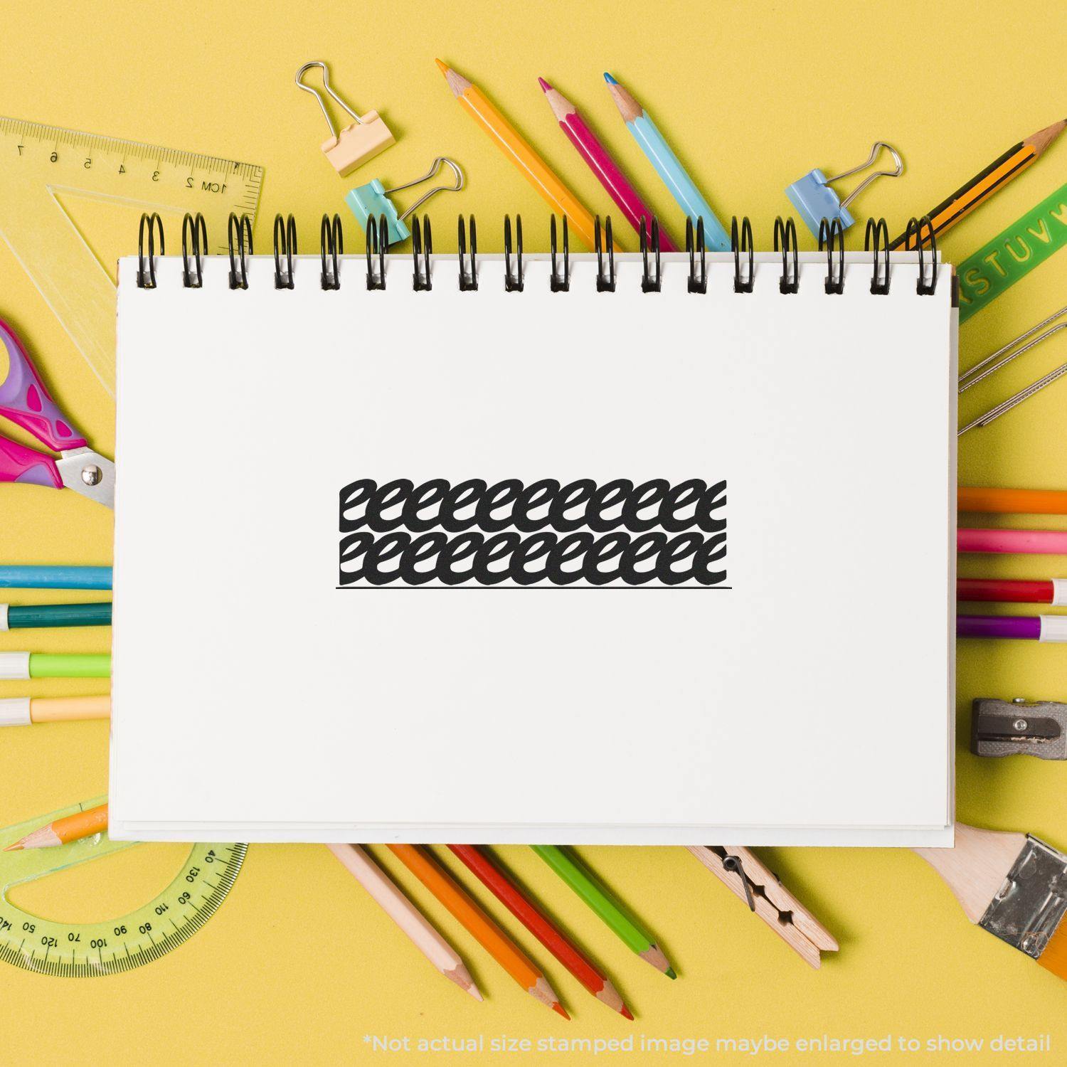 Large Self Inking Strikeout Stamp used on a white notebook page surrounded by colorful stationery on a yellow background.