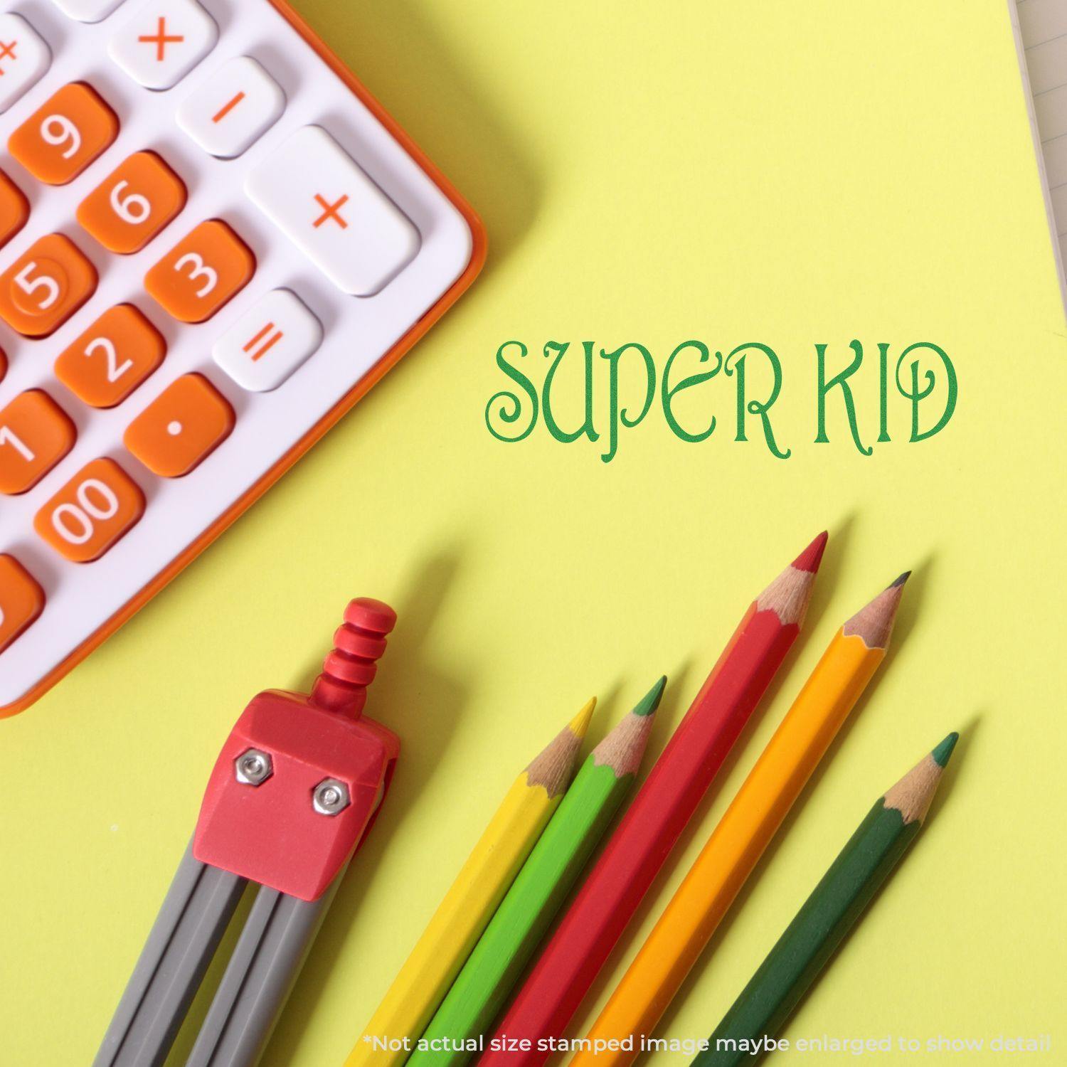 Super Kid Rubber Stamp on yellow paper with colorful pencils, a robot eraser, and a calculator in the background.