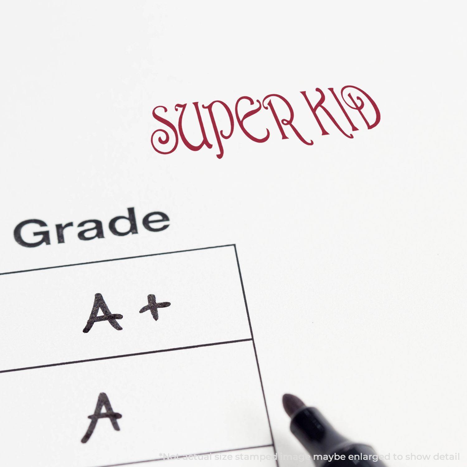 A paper with SUPER KID stamped in red ink using the Large Pre-Inked Super Kid Stamp, next to a grade section marked with A+ and A.