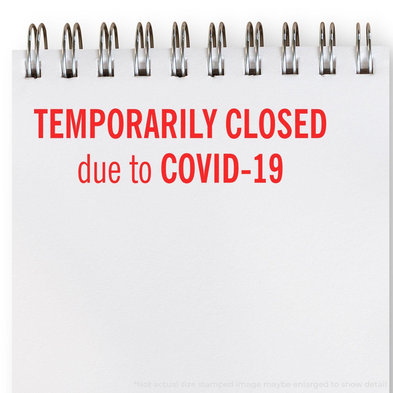 A stock office rubber stamp with a stamped image showing how the text "TEMPORARILY CLOSED due to COVID-19" in a large font is displayed after stamping.