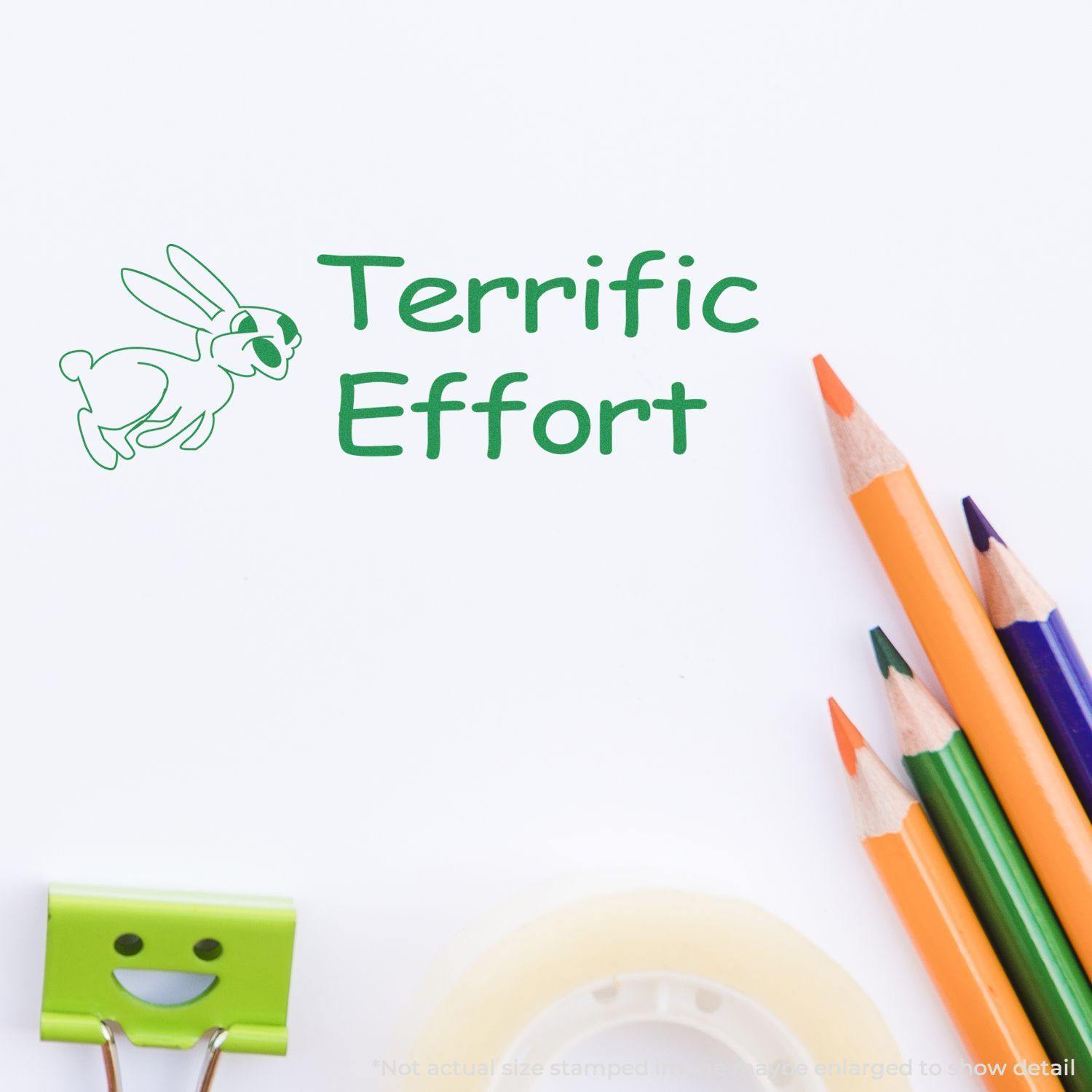 Terrific Effort rubber stamp in green ink with a rabbit illustration, surrounded by colorful pencils, a smiling clip, and tape.