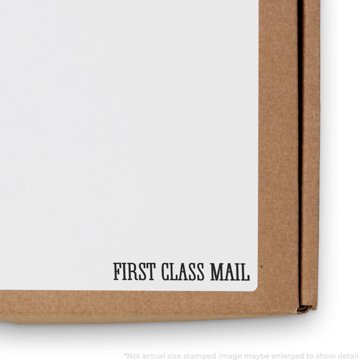 Large Pre-Inked Times First Class Mail Stamp used on a cardboard box, showing the clear FIRST CLASS MAIL imprint on white label.