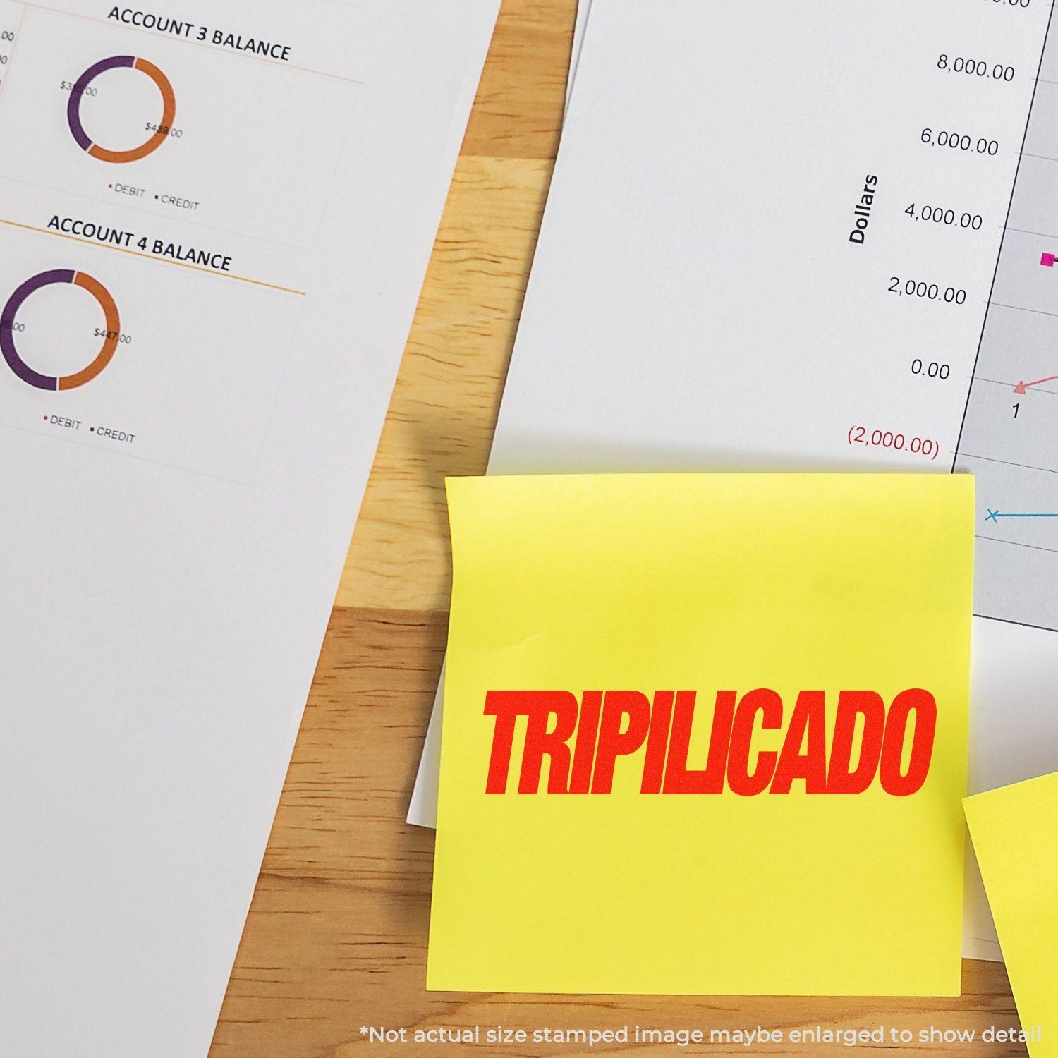 Large Pre-Inked Tripilicado Stamp used on a yellow sticky note, placed on a desk with financial documents and charts in the background.