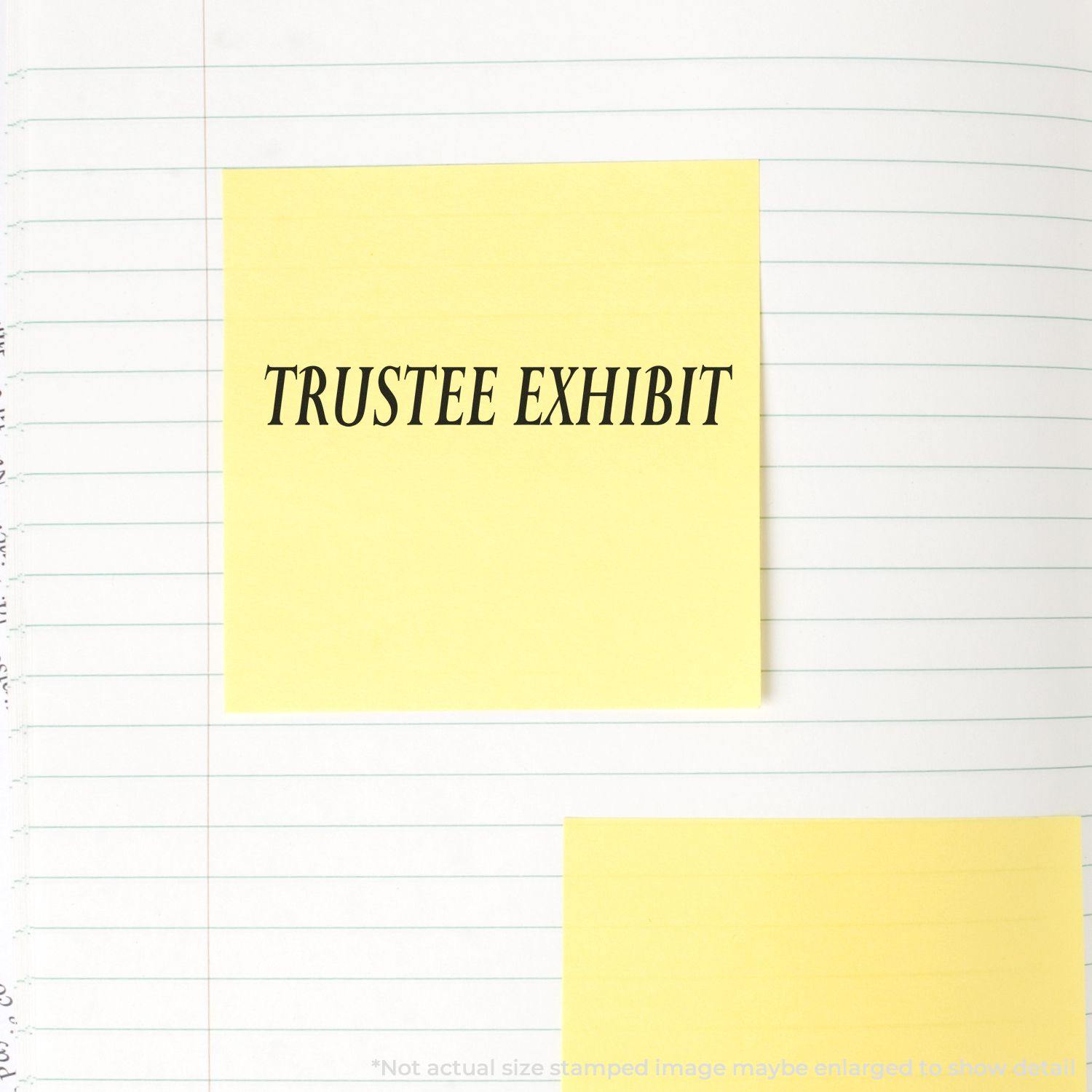 Large Pre-Inked Trustee Exhibit Stamp used on a yellow sticky note placed on a lined notebook page.