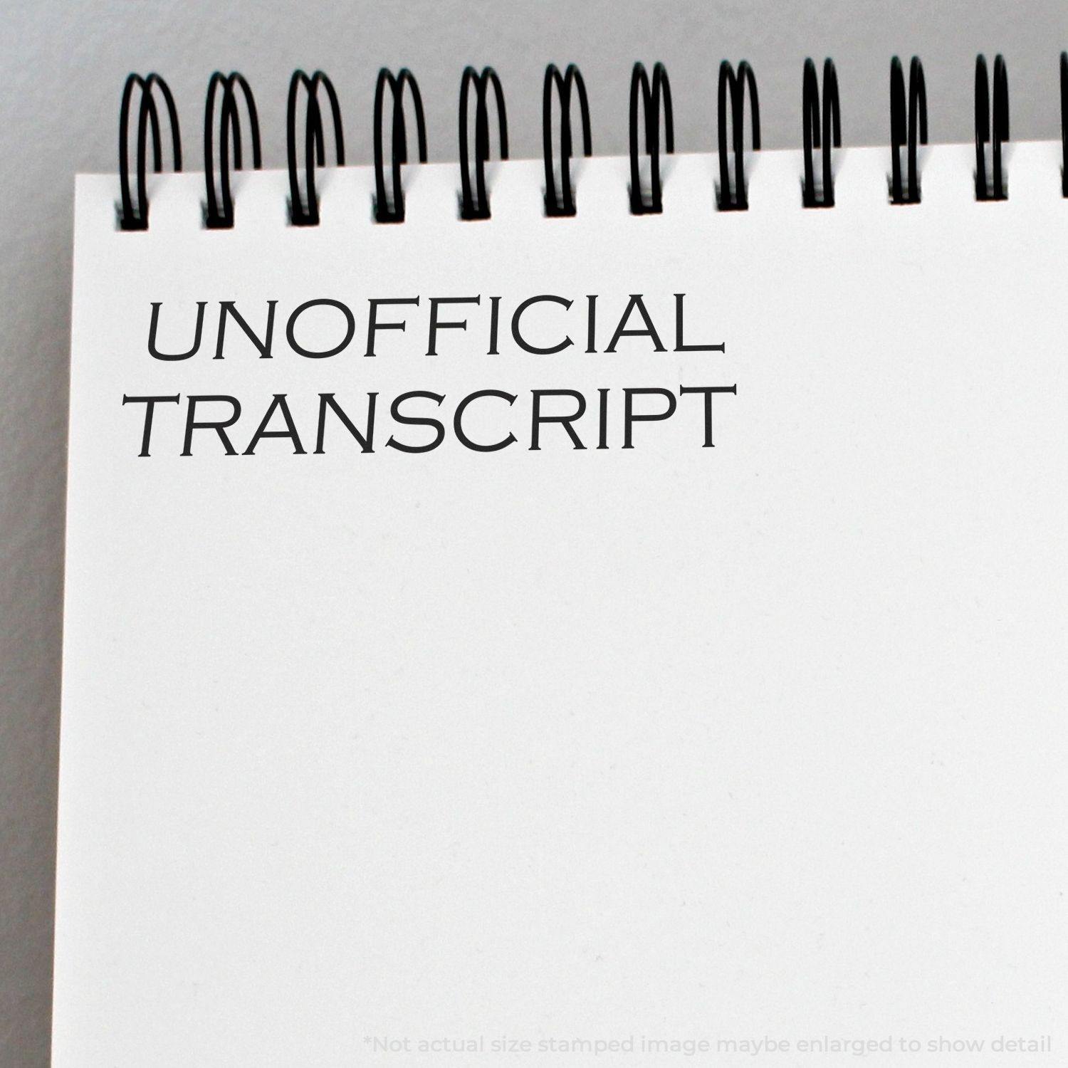 A Self Inking Unofficial Transcript Stamp marks UNOFFICIAL TRANSCRIPT on a white spiral-bound notebook page.