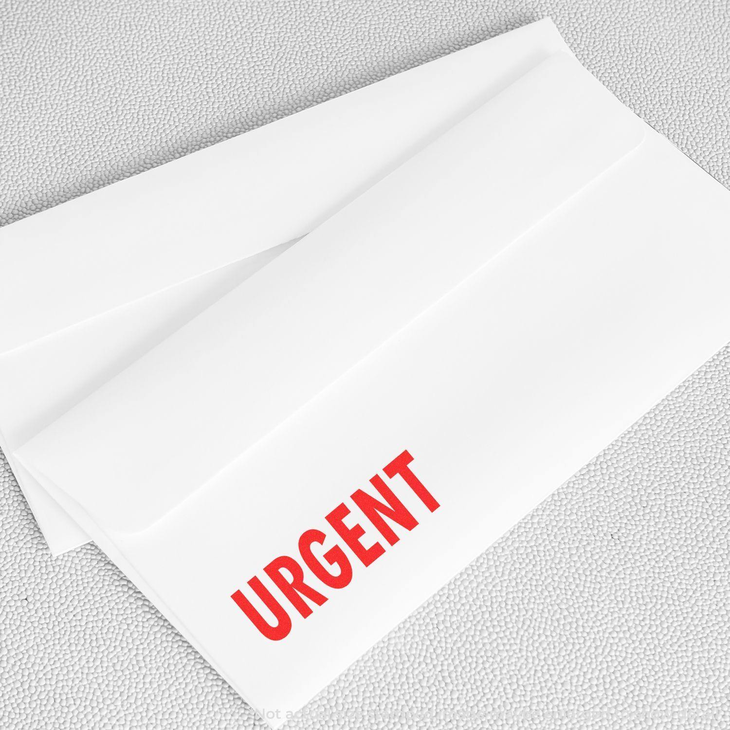 Two white envelopes stamped with URGENT in red using the Large Pre-Inked Urgent Stamp, placed on a textured surface.