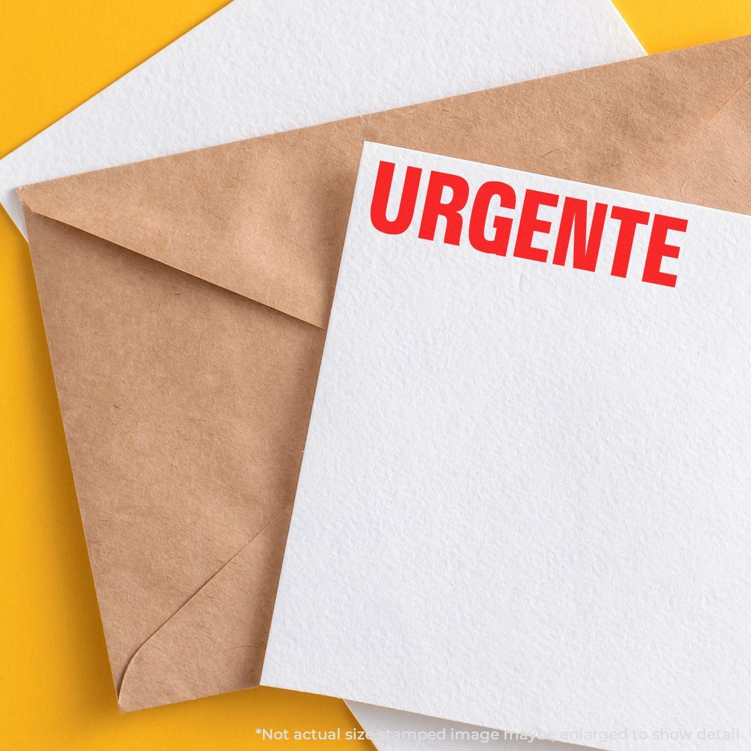 Large Self Inking Urgente Stamp used on a white card, placed beside a brown envelope on a yellow background.