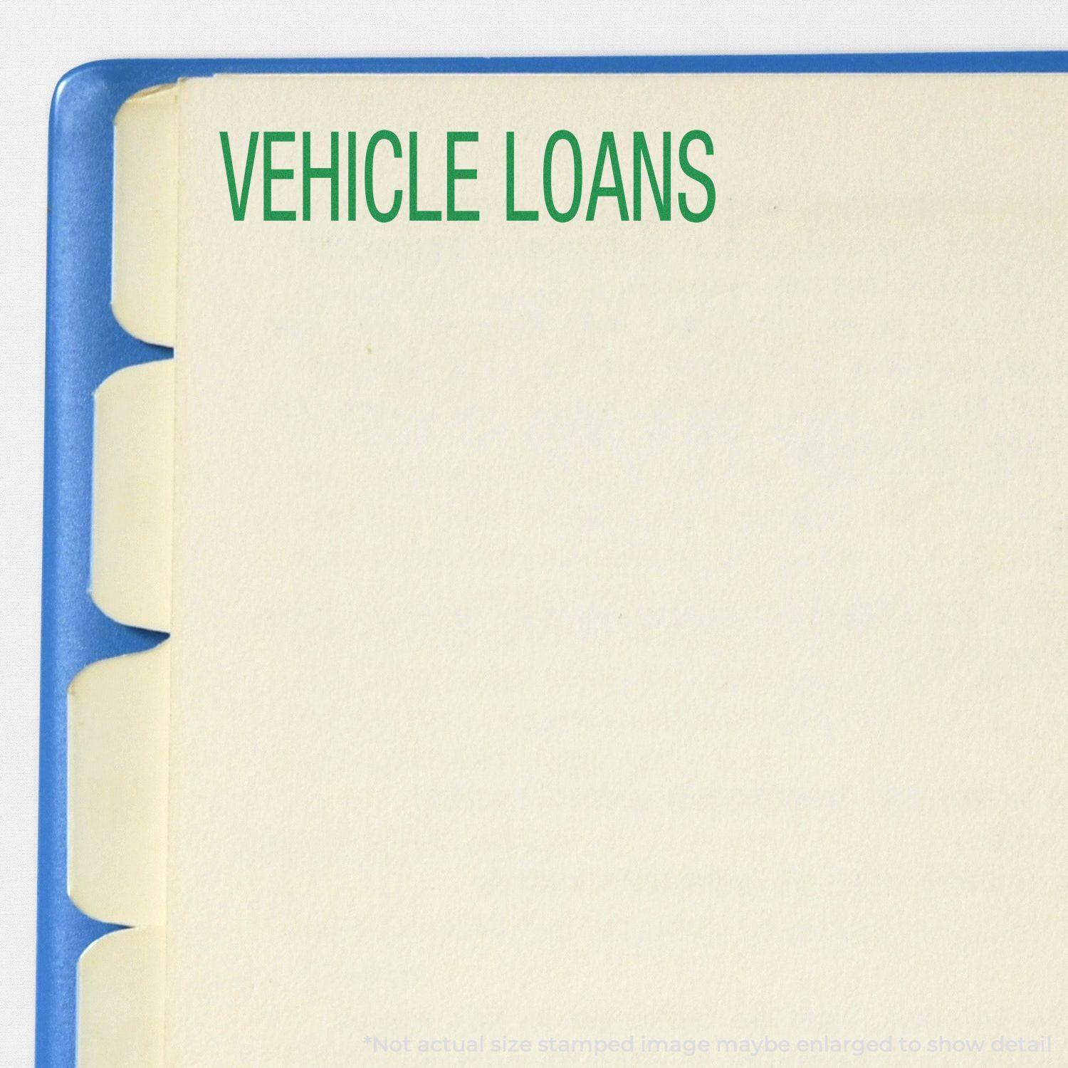 A self-inking stamp with a stamped image showing how the text "VEHICLE LOANS" in a large bold font is displayed by it.