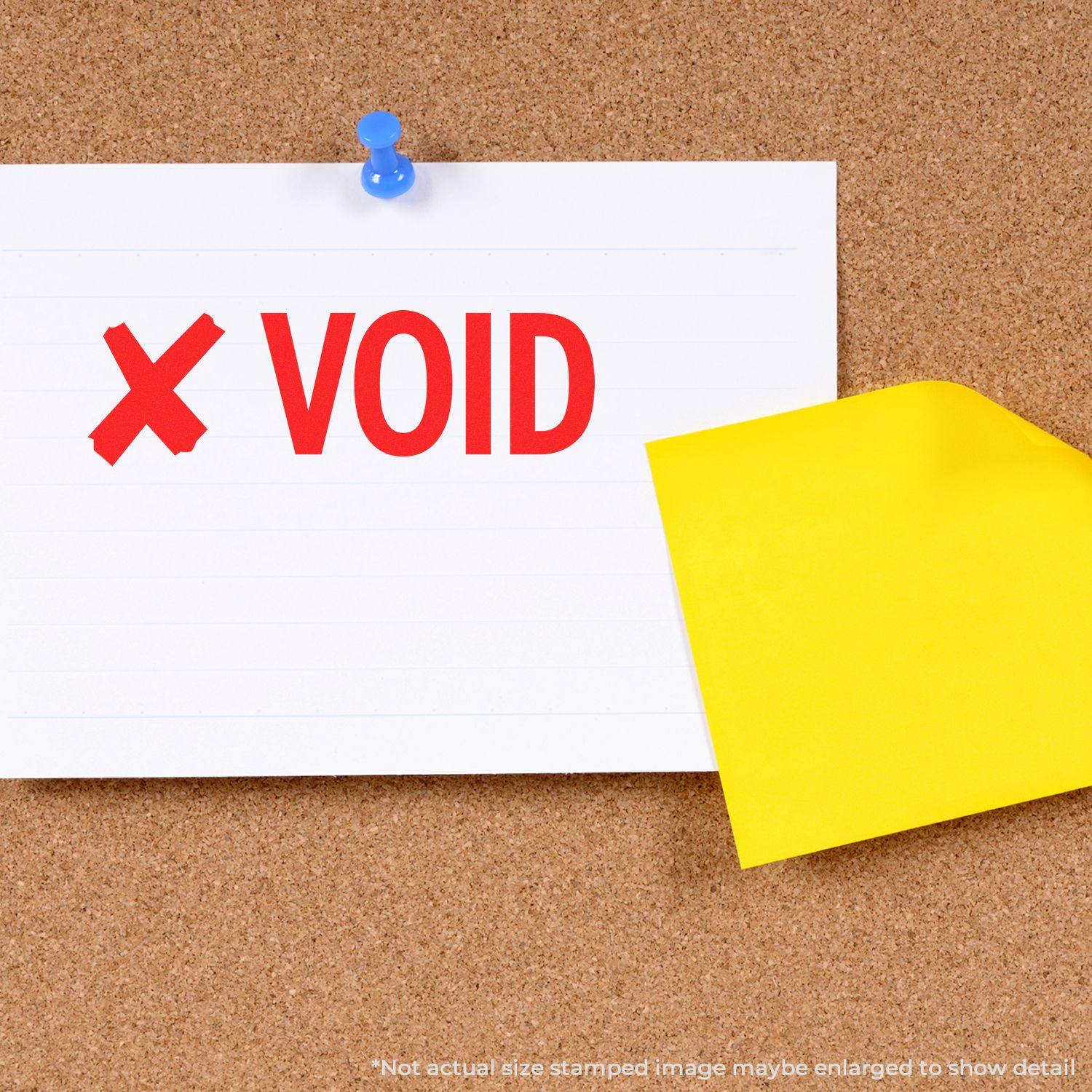 Slim Pre-Inked Void with X Stamp on a white paper pinned to a corkboard, with a yellow sticky note partially covering the paper.