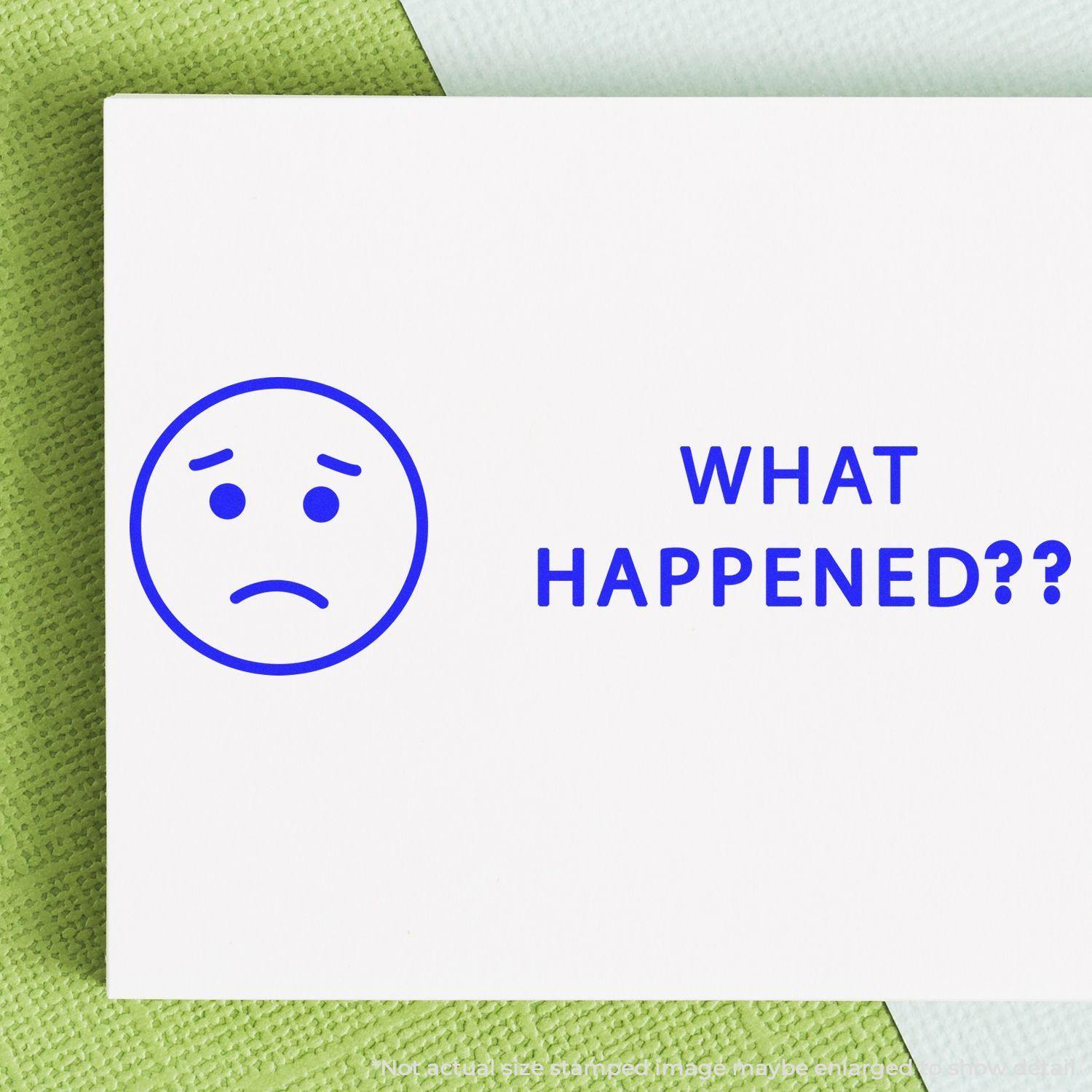 A stock office rubber stamp with a stamped image showing how the text "WHAT HAPPENED??" in bold font with a sad face image on the left side is displayed after stamping.