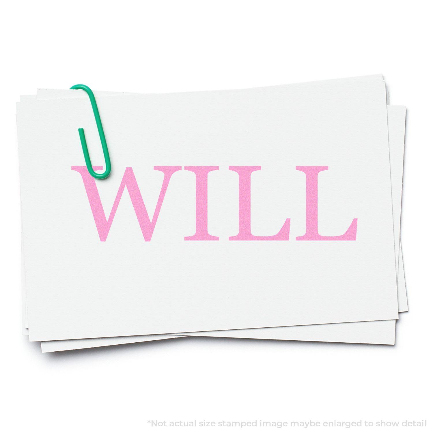 Large Pre-Inked Will Stamp in pink ink on white paper, secured with a green paperclip.