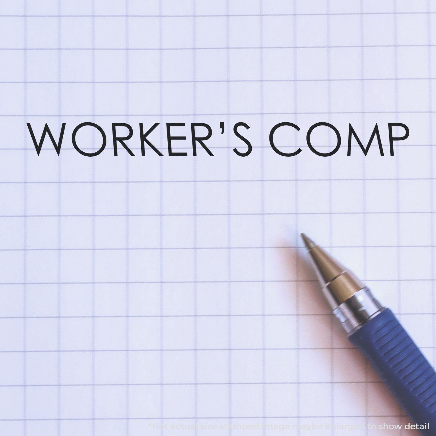 Large Pre-Inked Workers Comp Stamp used on graph paper with a blue pen beside the stamped text "WORKER'S COMP".