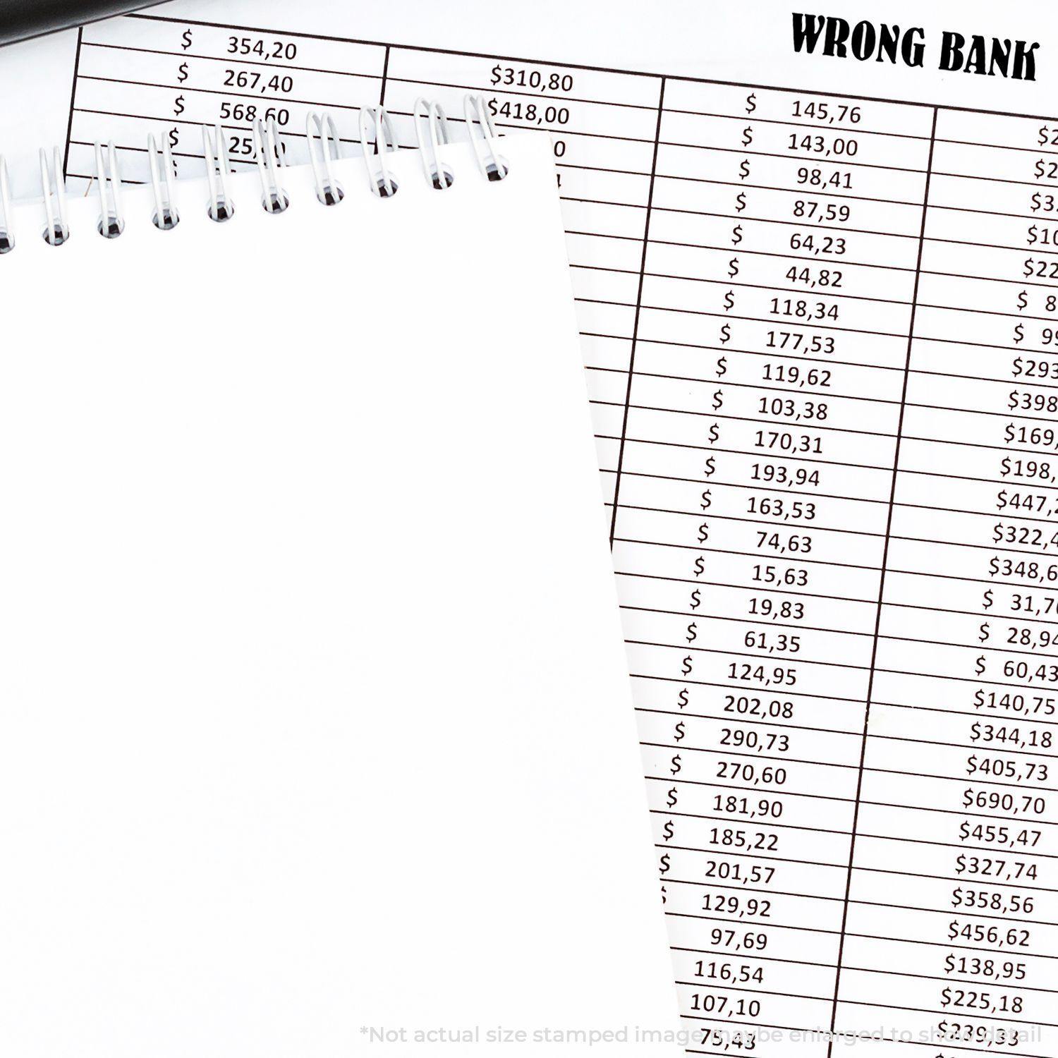 Large Pre-Inked Wrong Bank Stamp used on a financial document with a spiral notebook and pen nearby.