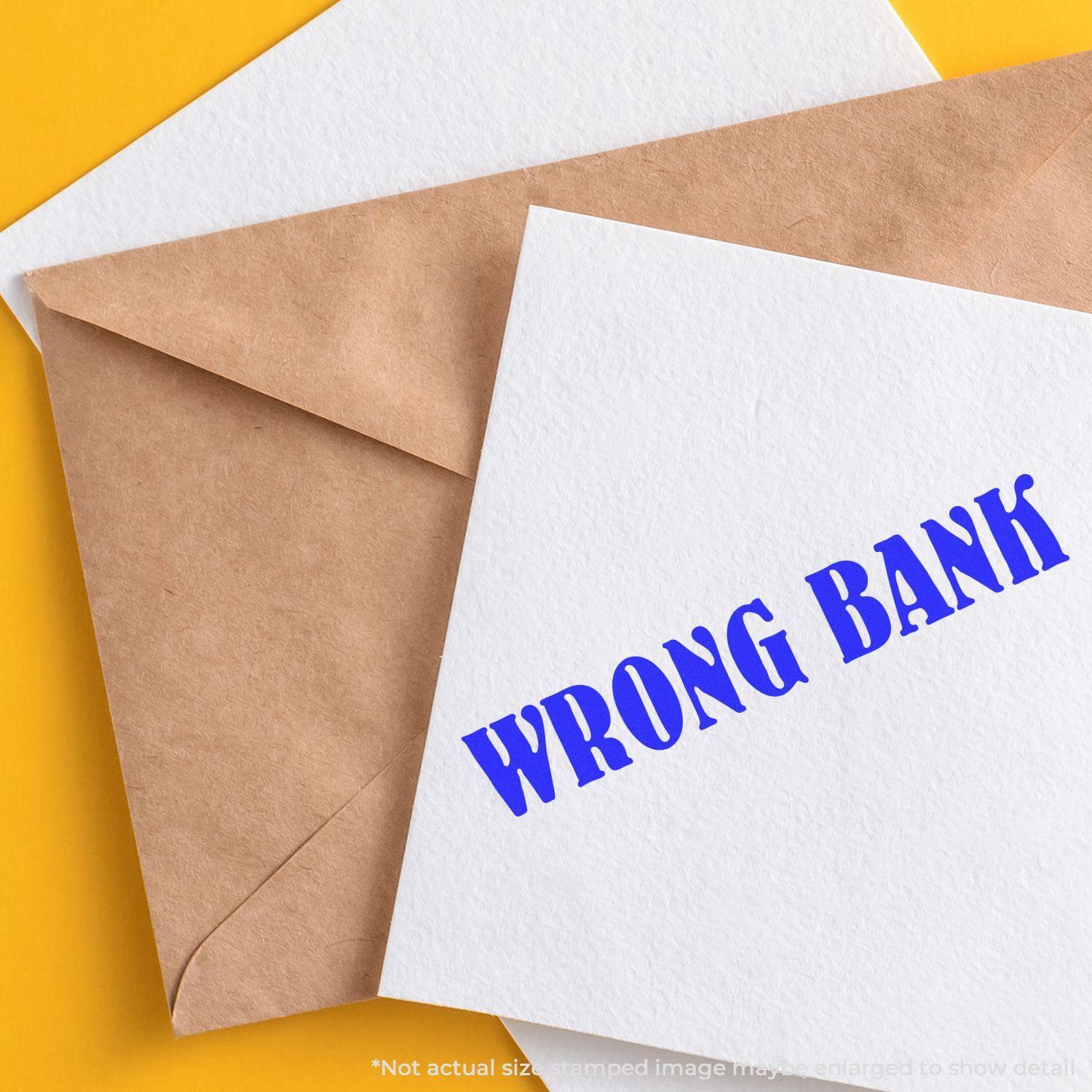 Large Pre-Inked Wrong Bank Stamp in blue ink on a white card, placed next to a brown envelope on a yellow background.