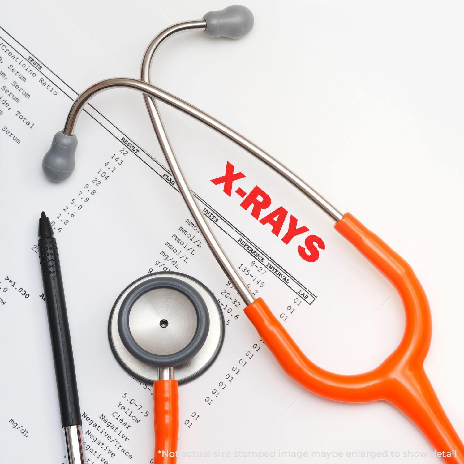 A stethoscope and pen lie on a medical document stamped with "X-RAYS" using the Large X-Rays Rubber Stamp.