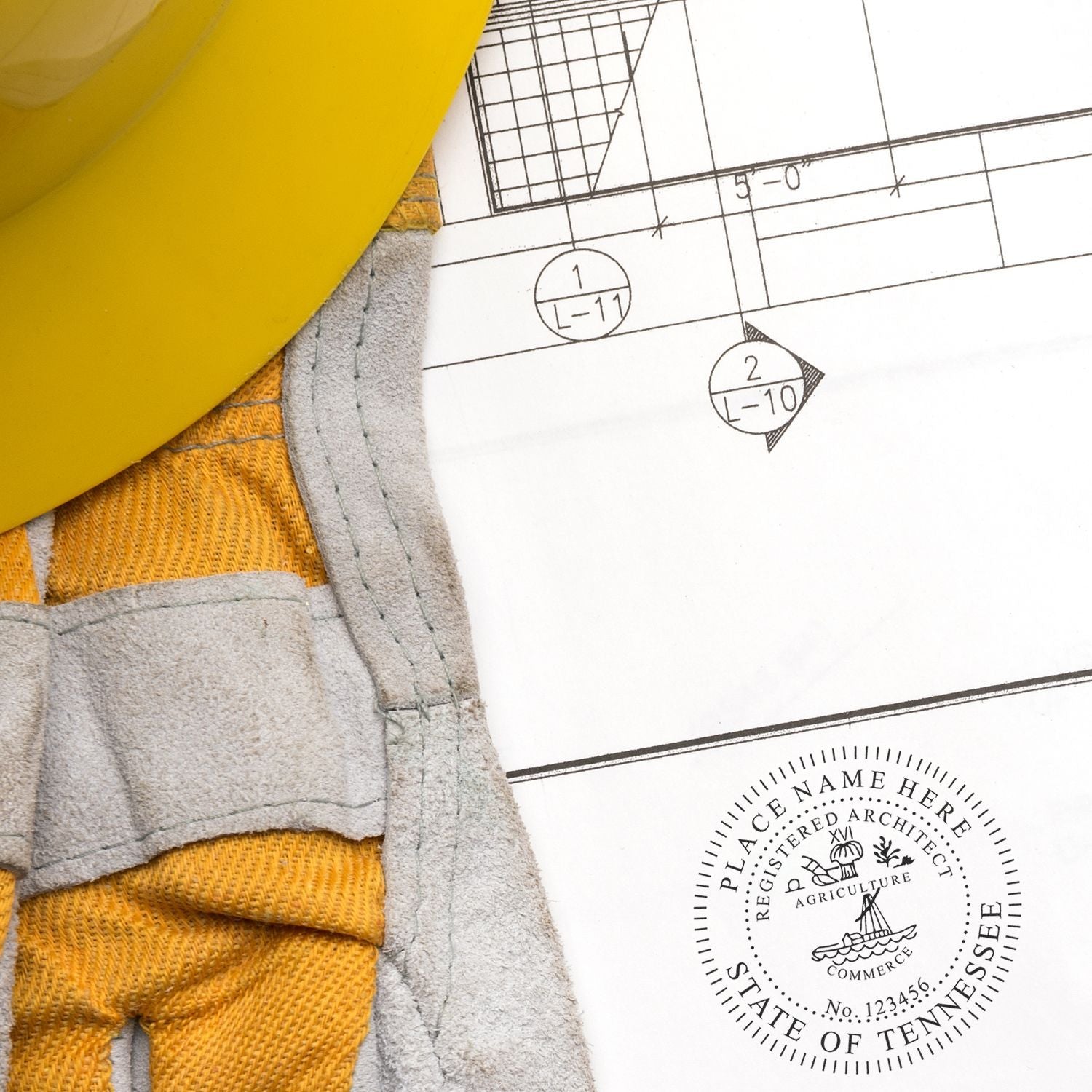 Premium MaxLight Pre-Inked Tennessee Architectural Stamp on architectural blueprint with yellow hard hat and work gloves nearby.