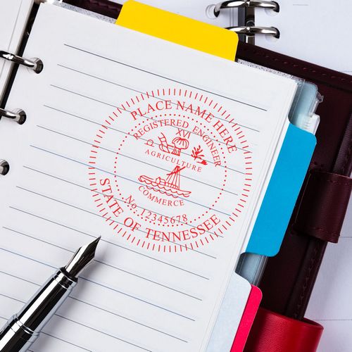 MaxLight Pre-Inked Professional Engineer Stamp of Seal for Tennessee displayed on a notebook page with a pen and colorful dividers in the background.