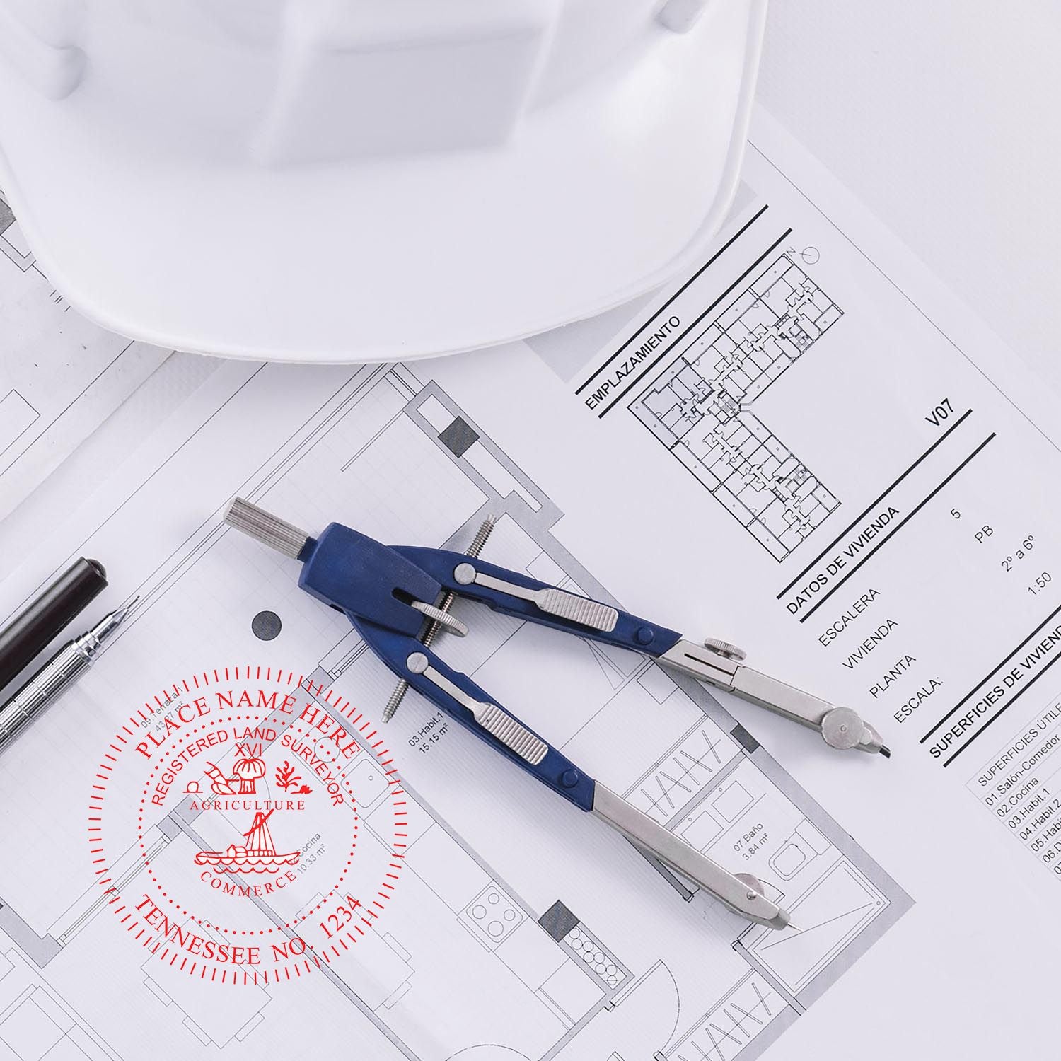 Self Inking Tennessee Land Surveyor Stamp on architectural plans with a compass, pen, and white hard hat in the background.