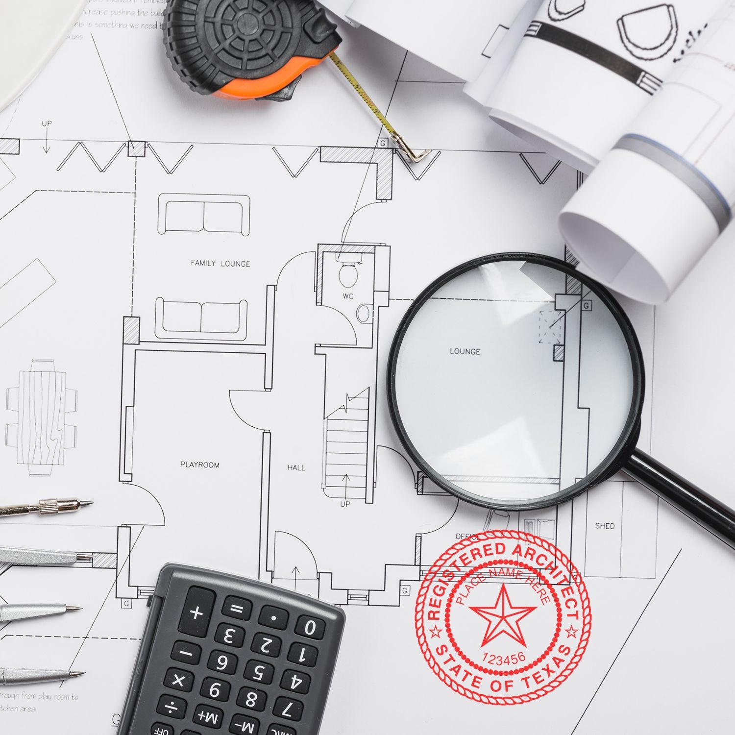 Architectural tools and blueprints with a Texas Architect Seal Stamp prominently displayed in red on the plans.