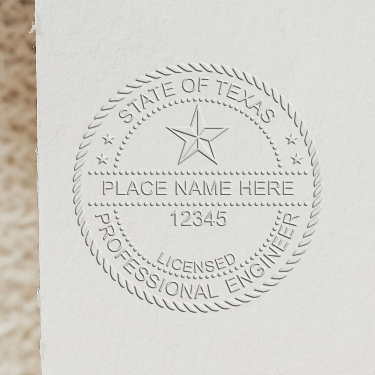 An alternative view of the Heavy Duty Cast Iron Texas Engineer Seal Embosser stamped on a sheet of paper showing the image in use