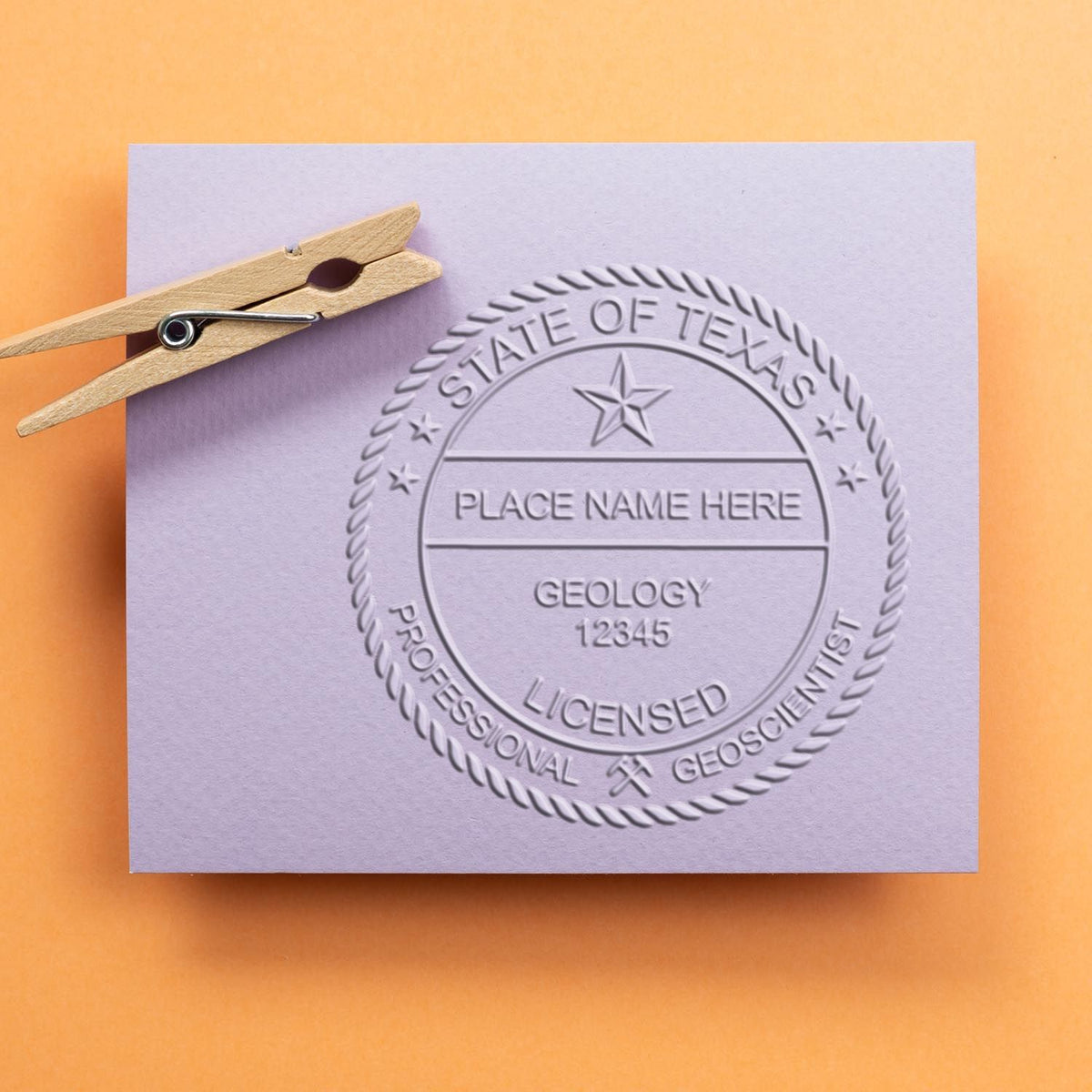 An in use photo of the Gift Texas Geologist Seal showing a sample imprint on a cardstock