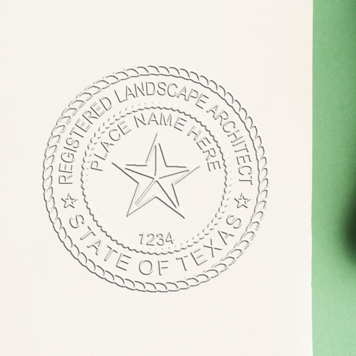 An in use photo of the Hybrid Texas Landscape Architect Seal showing a sample imprint on a cardstock