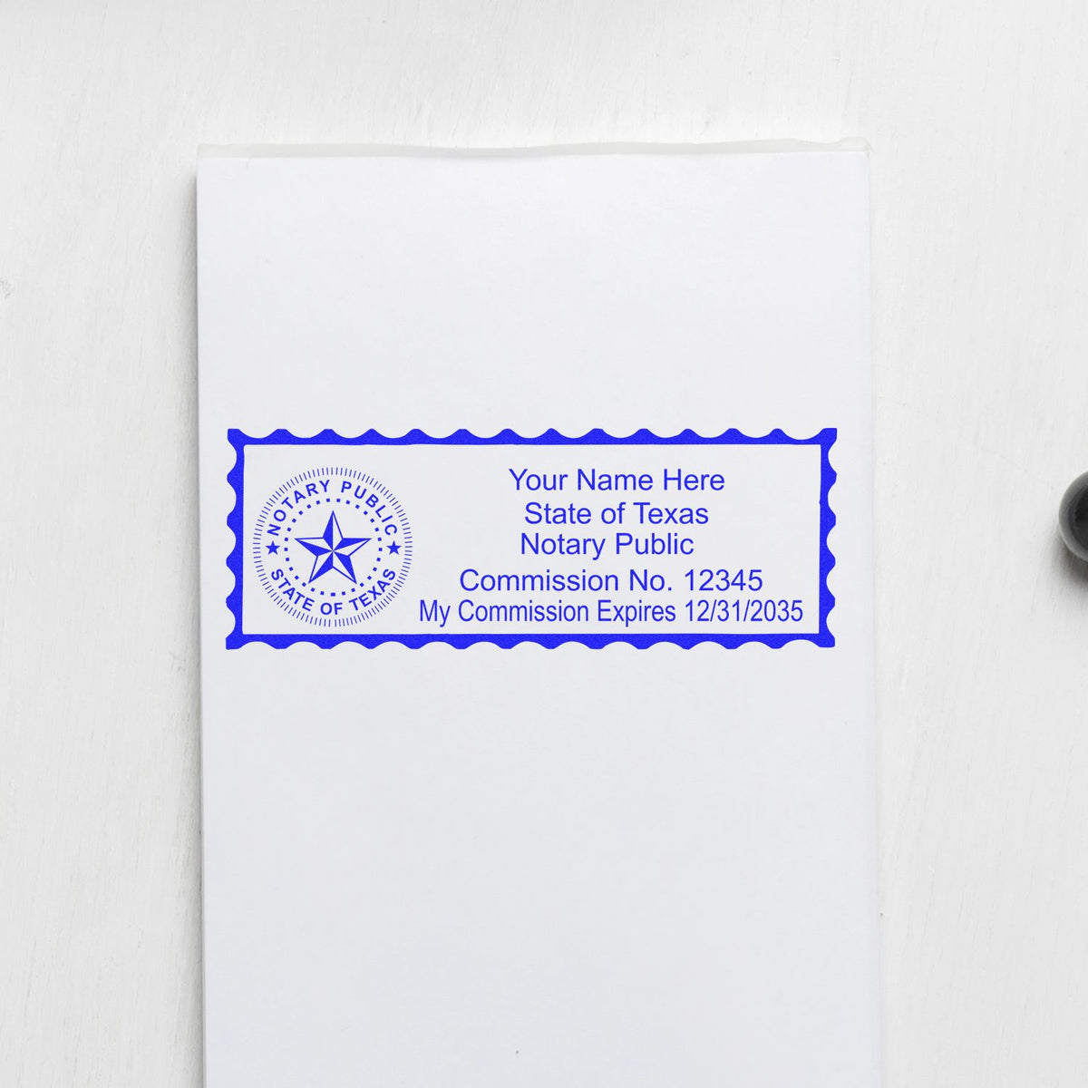 A lifestyle photo showing a stamped image of the Wooden Handle Texas State Seal Notary Public Stamp on a piece of paper
