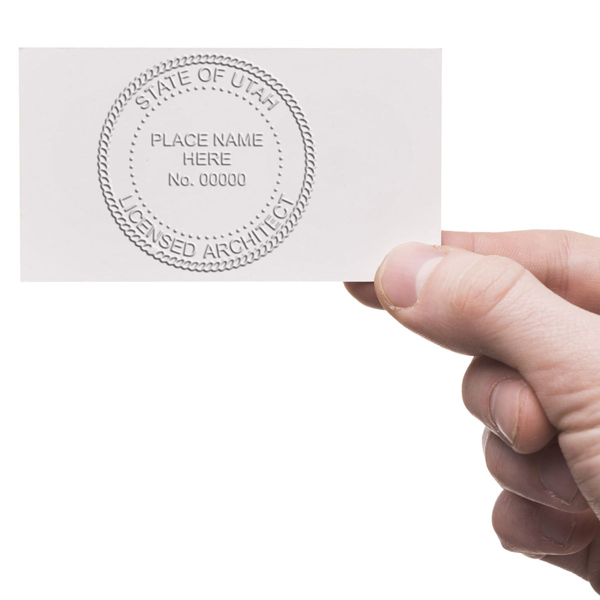 A lifestyle photo showing a stamped image of the Extended Long Reach Utah Architect Seal Embosser on a piece of paper
