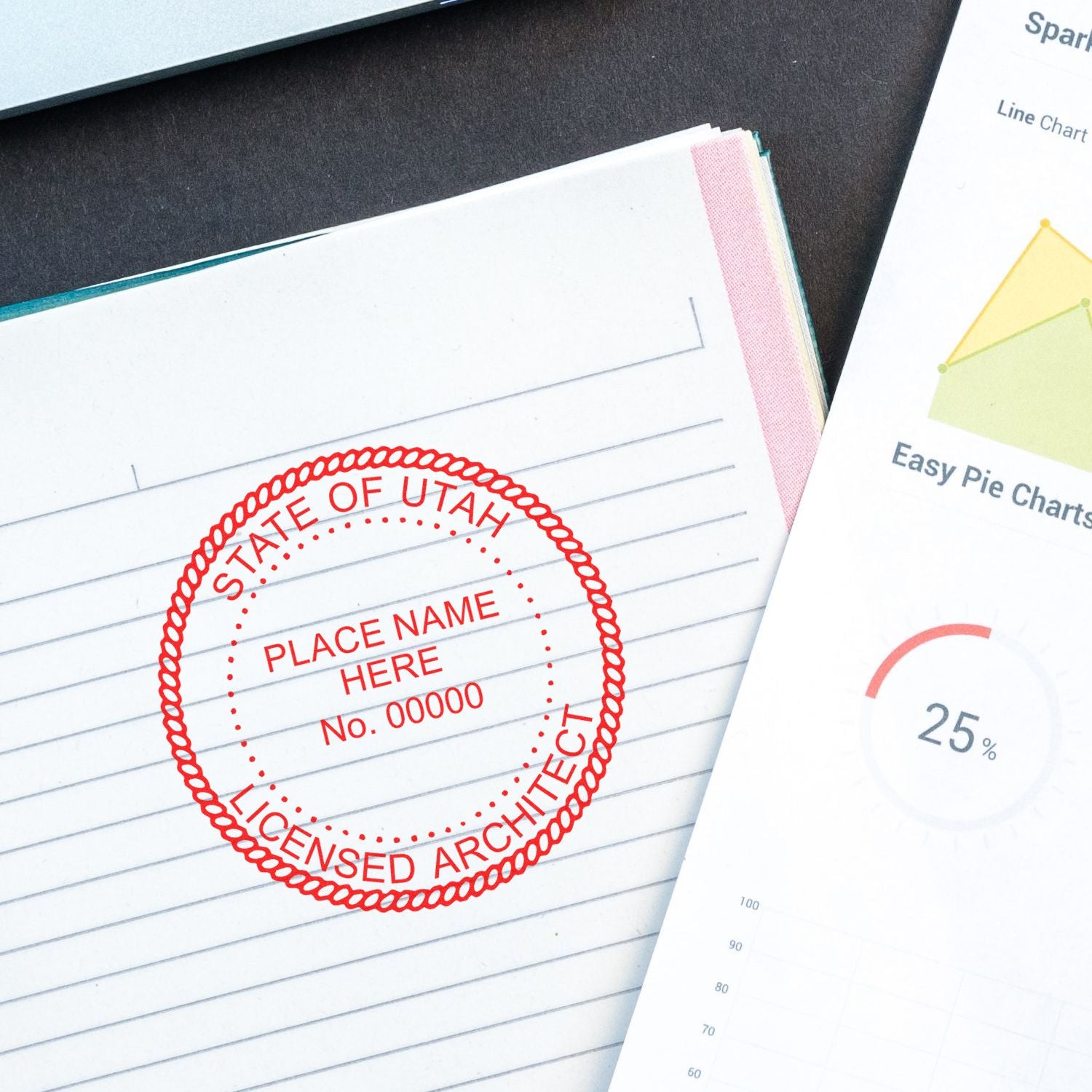 Self Inking Utah Architect Stamp in red ink on a lined paper, next to a chart document on a dark surface.