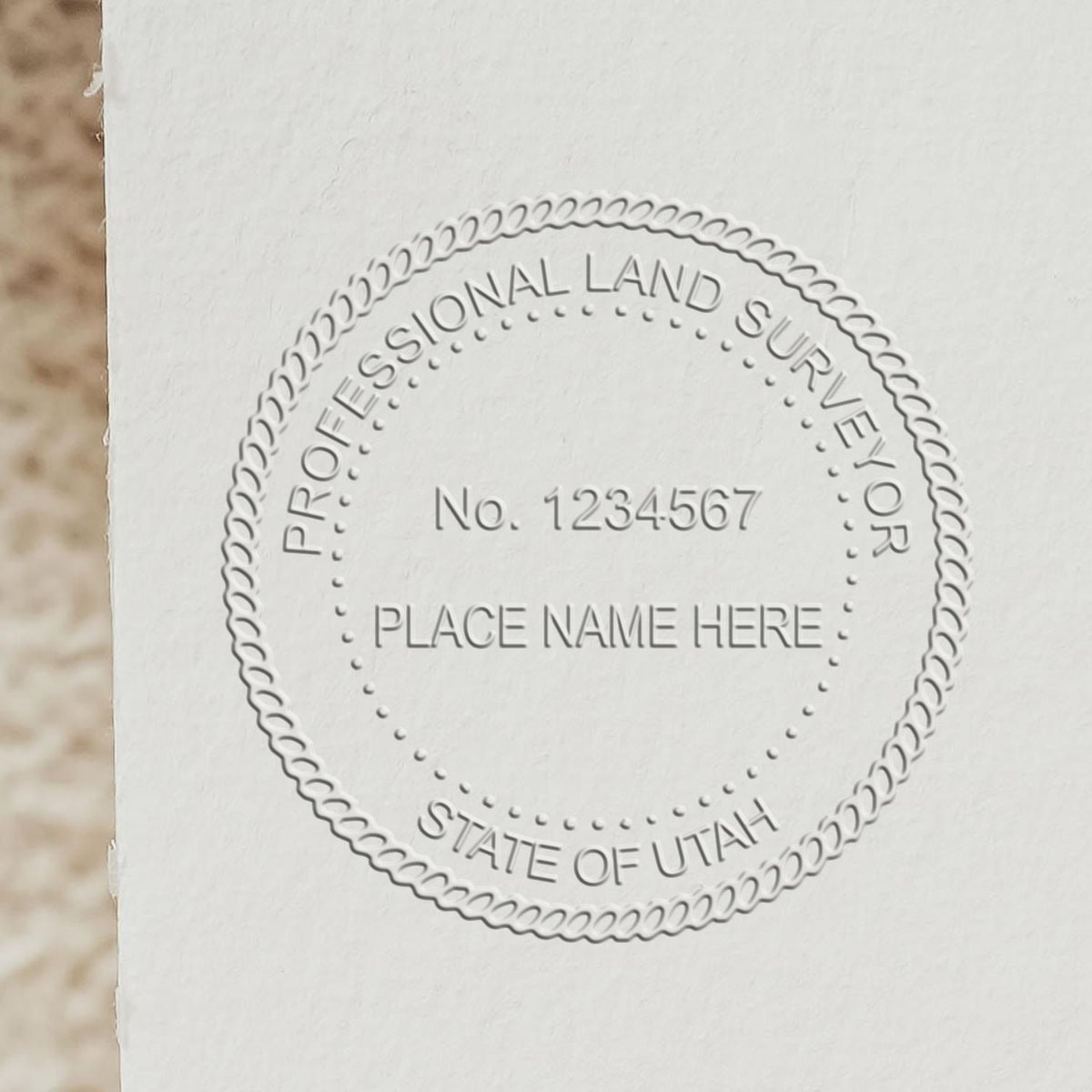 A lifestyle photo showing a stamped image of the State of Utah Soft Land Surveyor Embossing Seal on a piece of paper