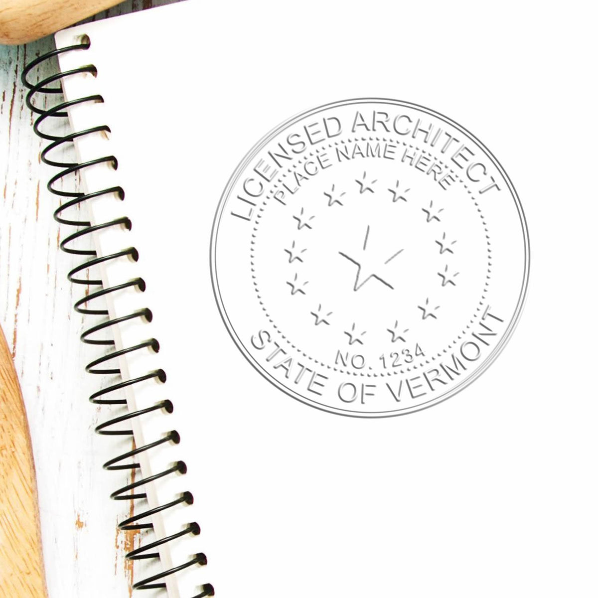 A lifestyle photo showing a stamped image of the Vermont Desk Architect Embossing Seal on a piece of paper