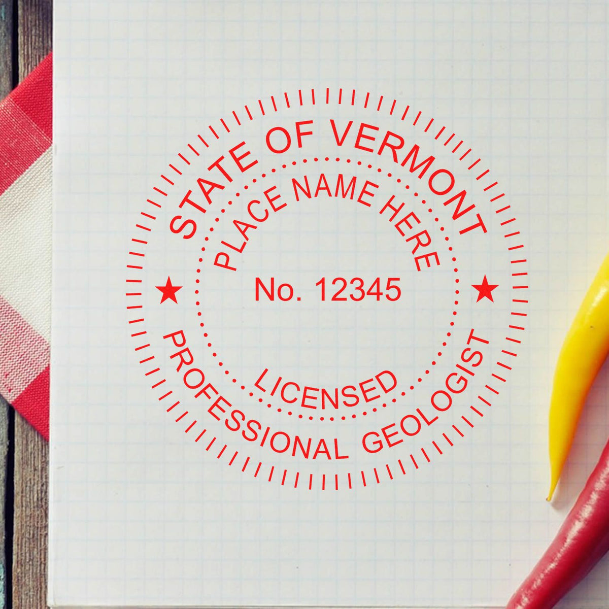 An in use photo of the Slim Pre-Inked Vermont Professional Geologist Seal Stamp showing a sample imprint on a cardstock
