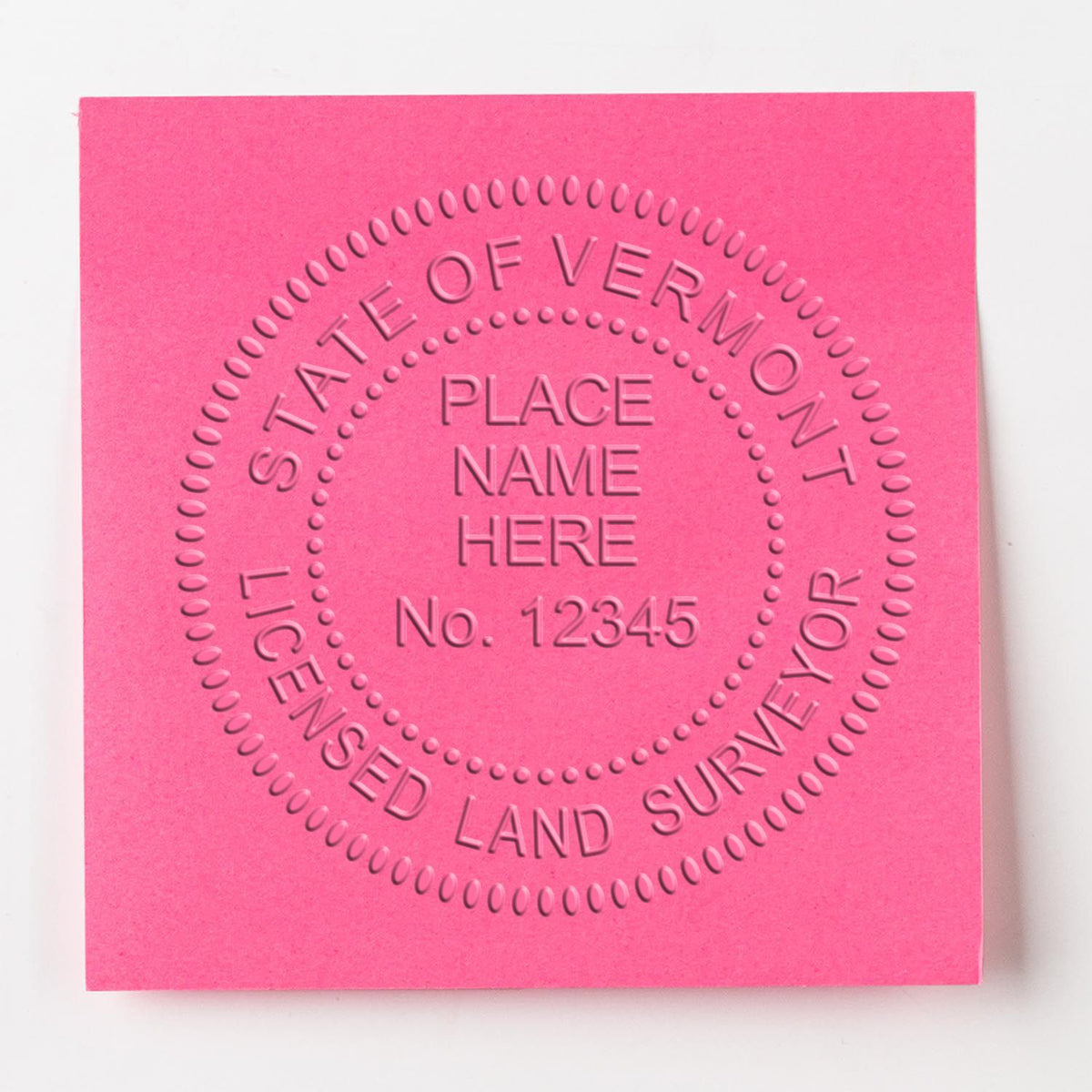 An in use photo of the Gift Vermont Land Surveyor Seal showing a sample imprint on a cardstock