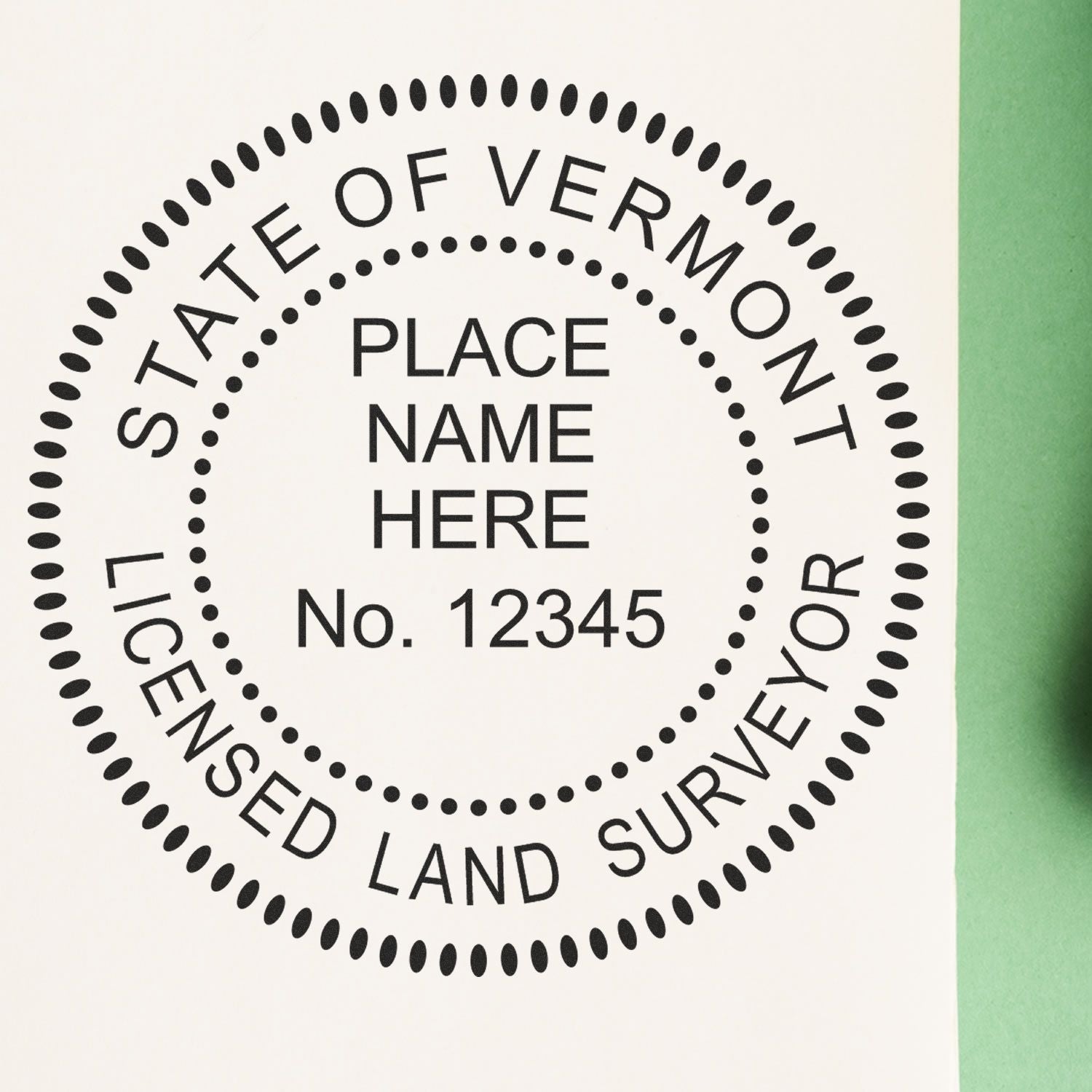 Image of a Premium MaxLight Pre-Inked Vermont Surveyors Stamp imprint with customizable text for place name and license number.