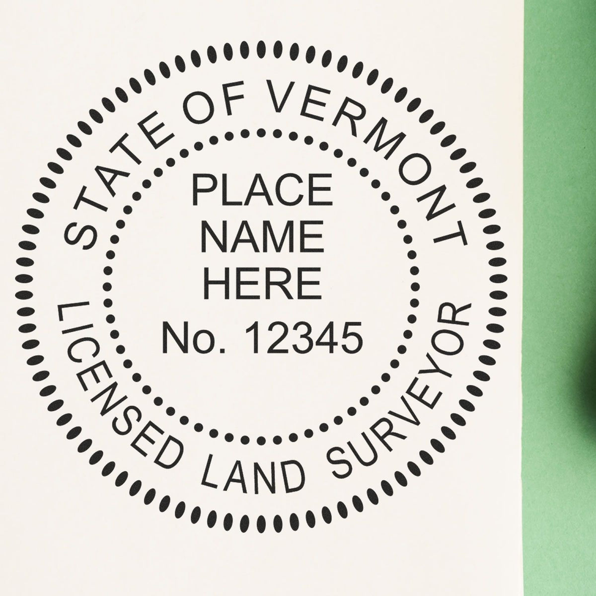 A lifestyle photo showing a stamped image of the Slim Pre-Inked Vermont Land Surveyor Seal Stamp on a piece of paper