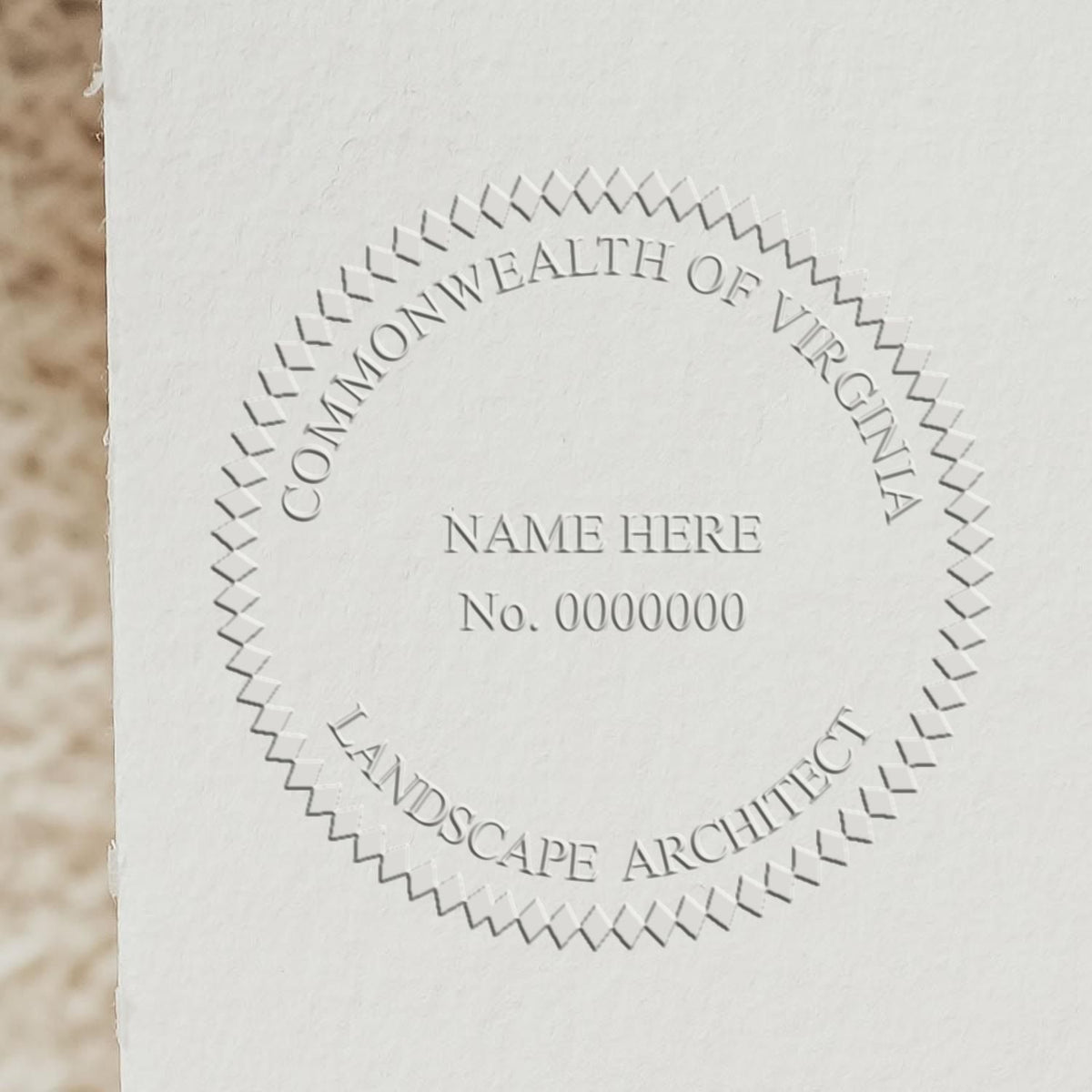 An in use photo of the Hybrid Virginia Landscape Architect Seal showing a sample imprint on a cardstock