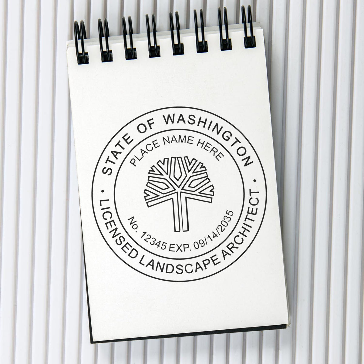 A lifestyle photo showing a stamped image of the Digital Washington Landscape Architect Stamp on a piece of paper