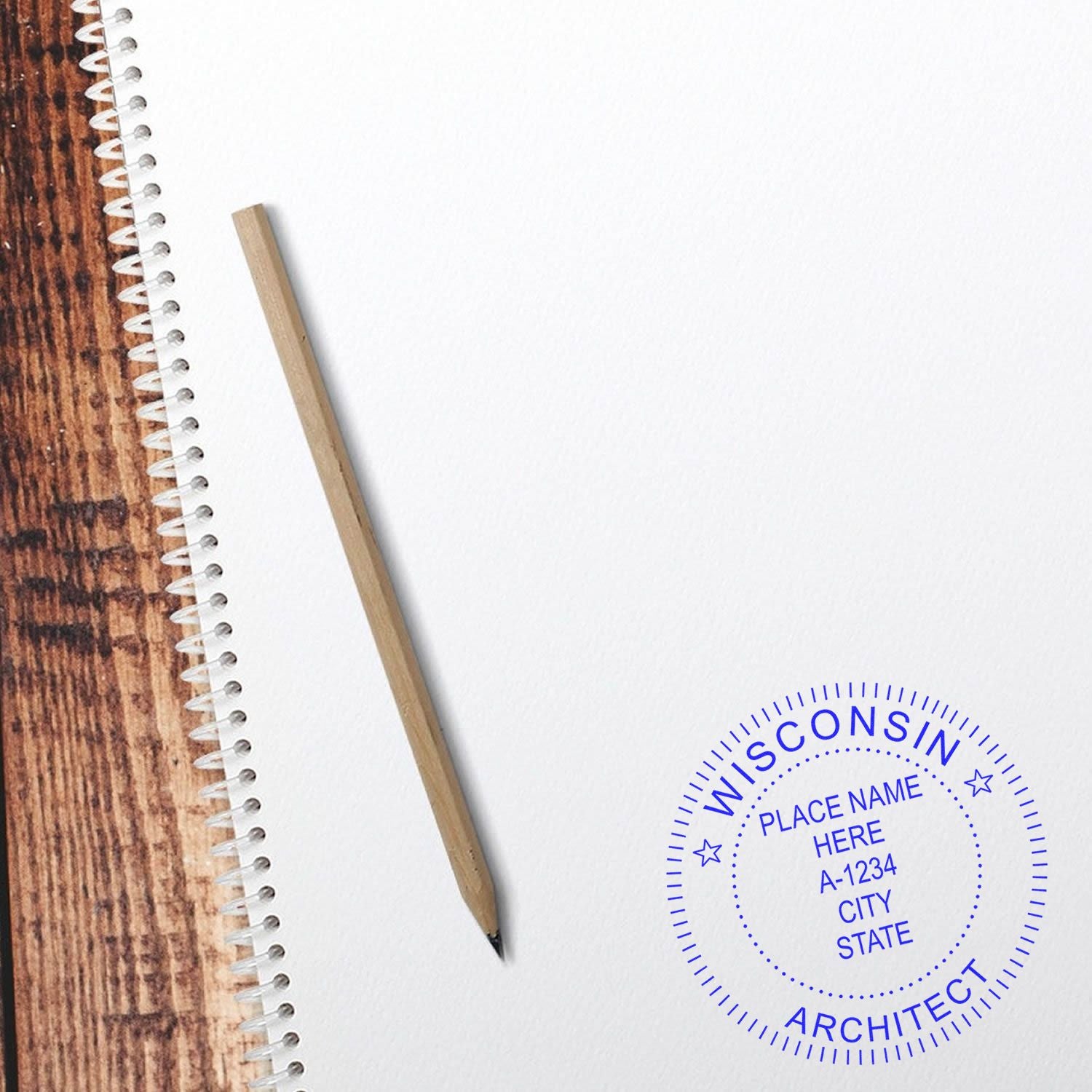 A wooden pencil on a spiral notebook with a blue Wisconsin Architect Seal Stamp on the bottom right corner of the page.