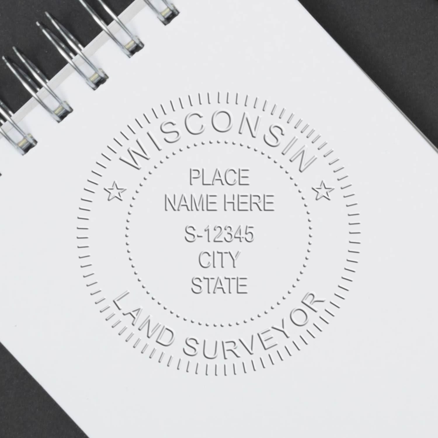 Another Example of a stamped impression of the Heavy Duty Cast Iron Wisconsin Land Surveyor Seal Embosser on a piece of office paper.