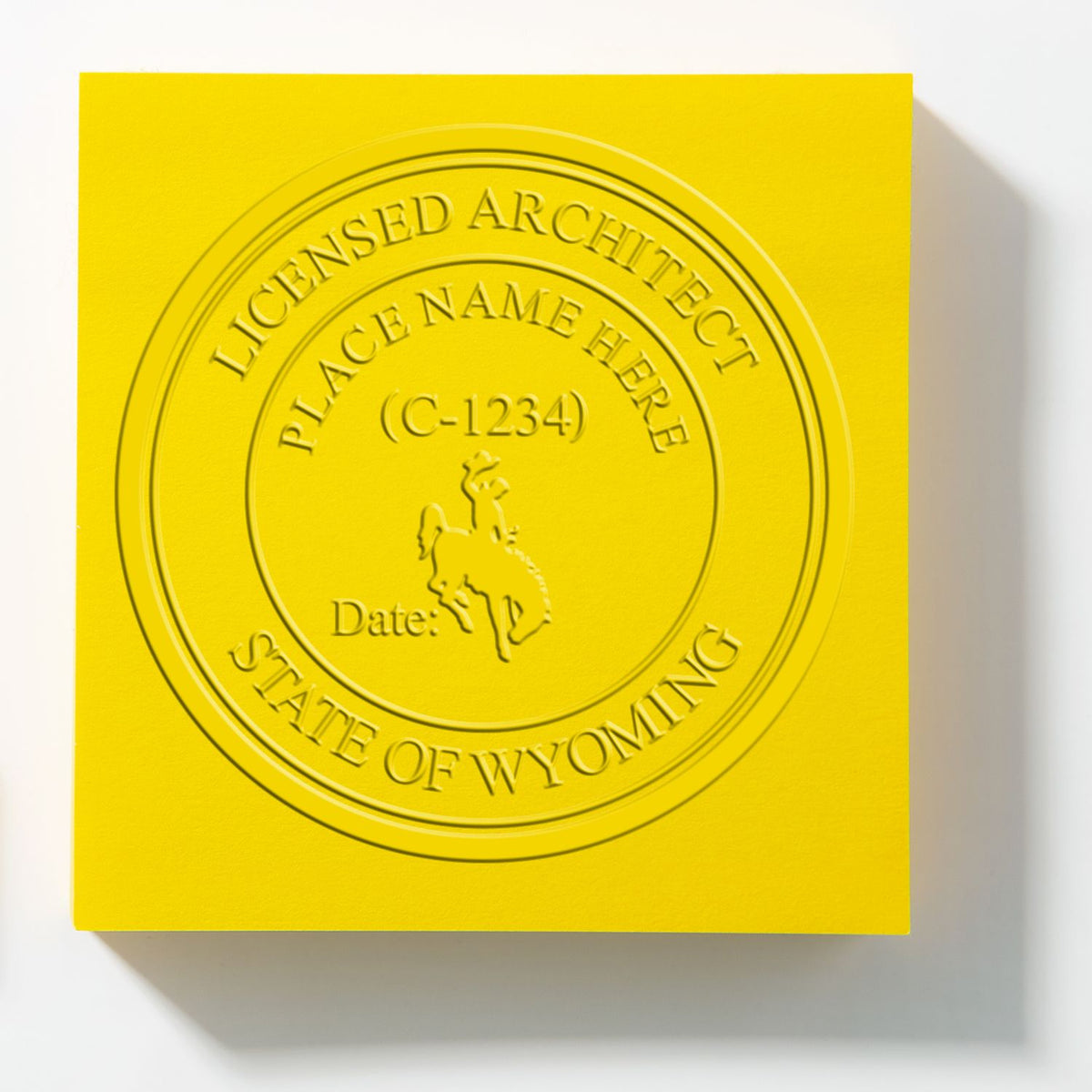 A lifestyle photo showing a stamped image of the Extended Long Reach Wyoming Architect Seal Embosser on a piece of paper