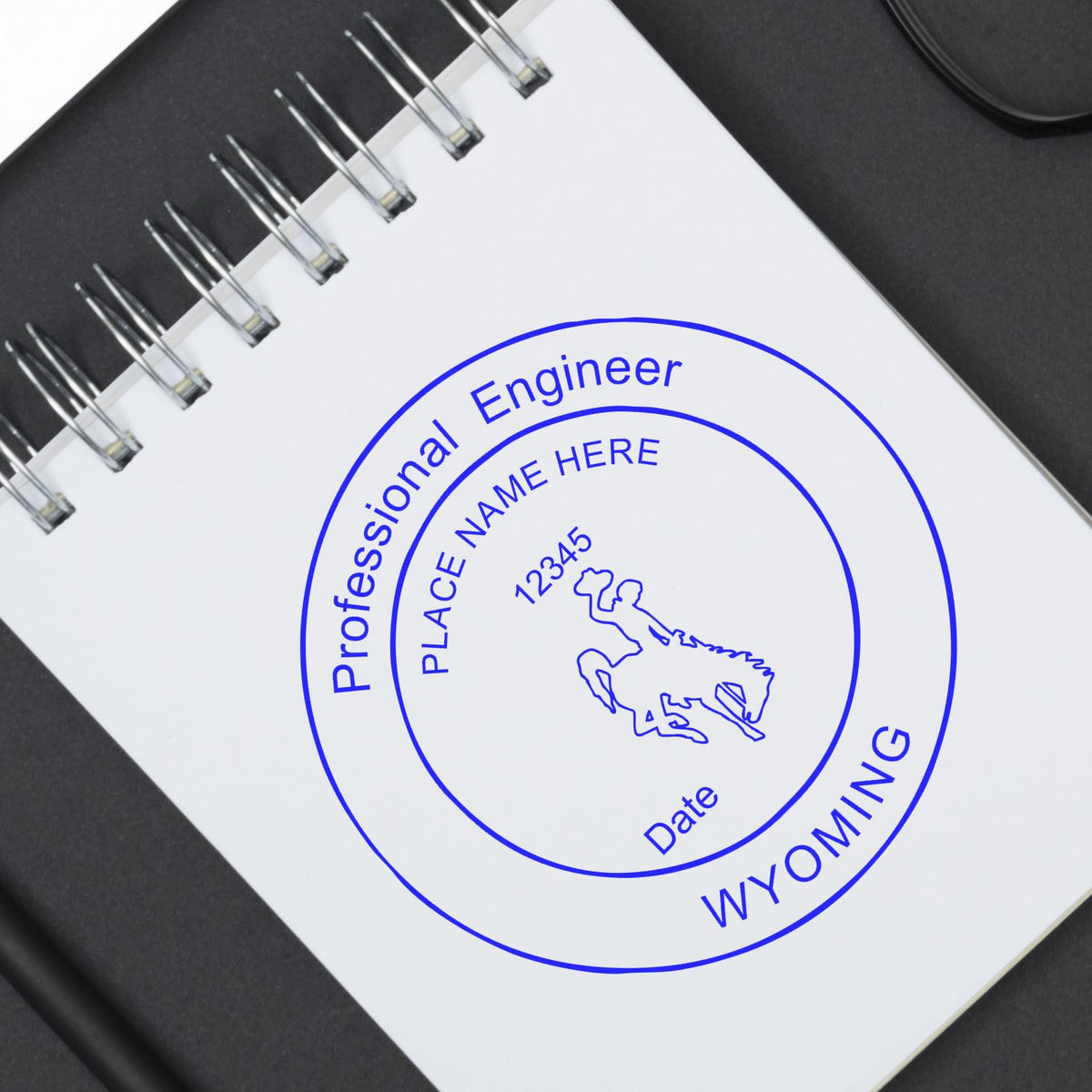 A lifestyle photo showing a stamped image of the Premium MaxLight Pre-Inked Wyoming Engineering Stamp on a piece of paper