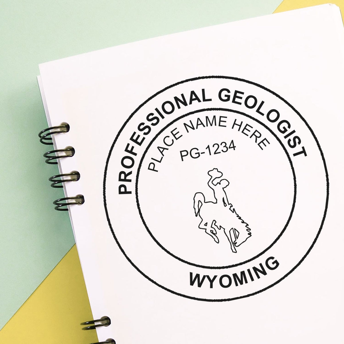 An in use photo of the Self-Inking Wyoming Geologist Stamp showing a sample imprint on a cardstock