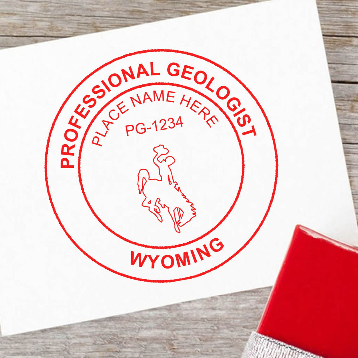 An in use photo of the Slim Pre-Inked Wyoming Professional Geologist Seal Stamp showing a sample imprint on a cardstock