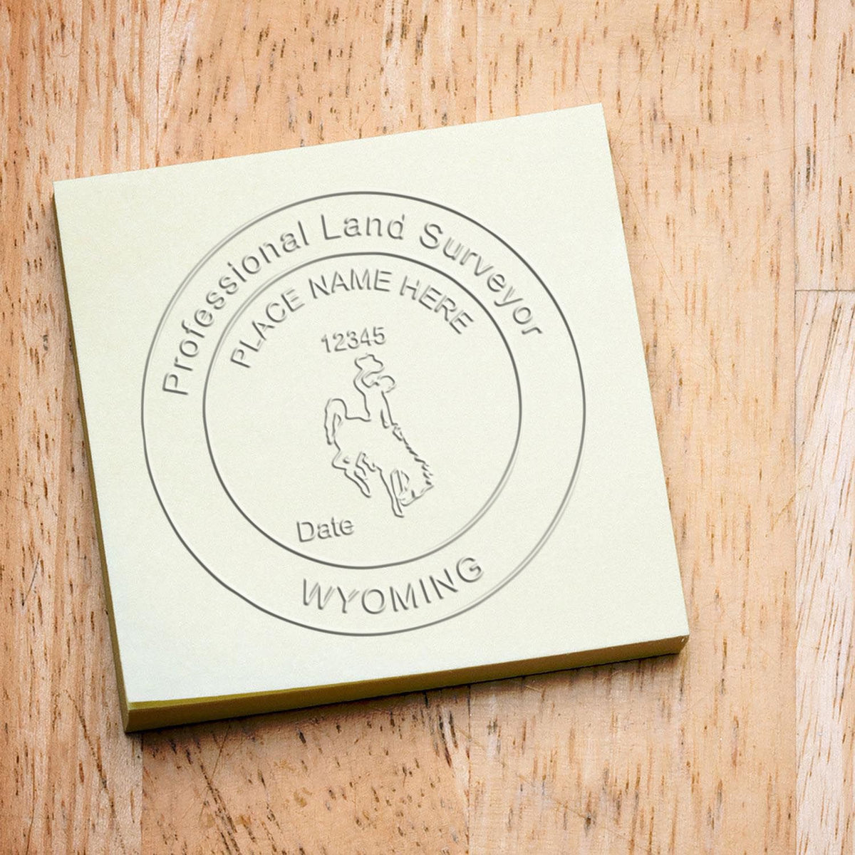 An in use photo of the Gift Wyoming Land Surveyor Seal showing a sample imprint on a cardstock
