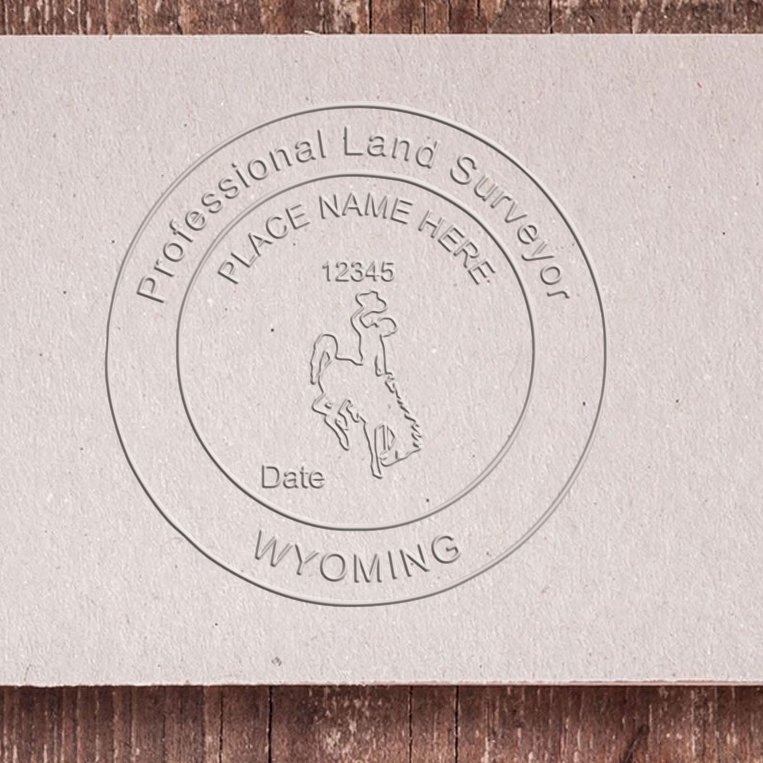 A lifestyle photo showing a stamped image of the Wyoming Desk Surveyor Seal Embosser on a piece of paper