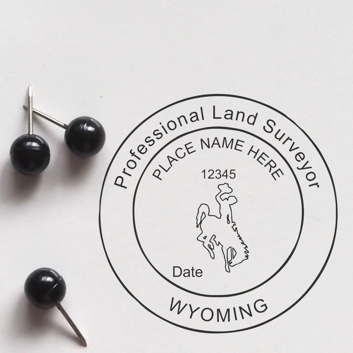 An alternative view of the Slim Pre-Inked Wyoming Land Surveyor Seal Stamp stamped on a sheet of paper showing the image in use