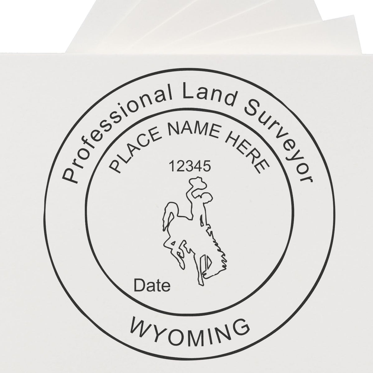A lifestyle photo showing a stamped image of the Slim Pre-Inked Wyoming Land Surveyor Seal Stamp on a piece of paper