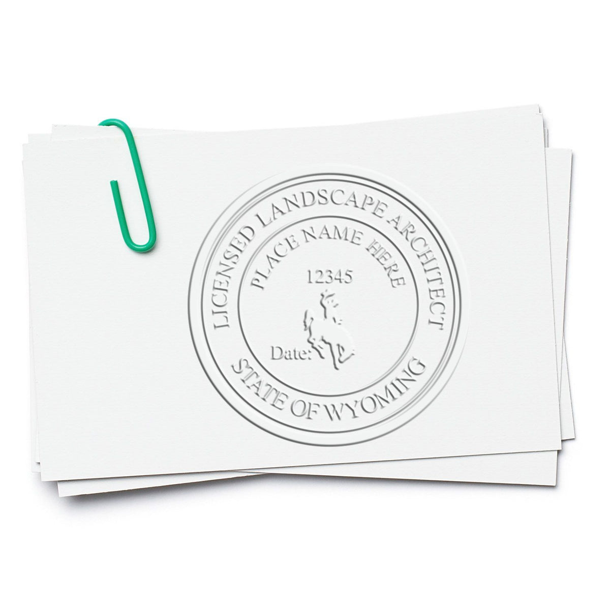 A lifestyle photo showing a stamped image of the Soft Pocket Wyoming Landscape Architect Embosser on a piece of paper