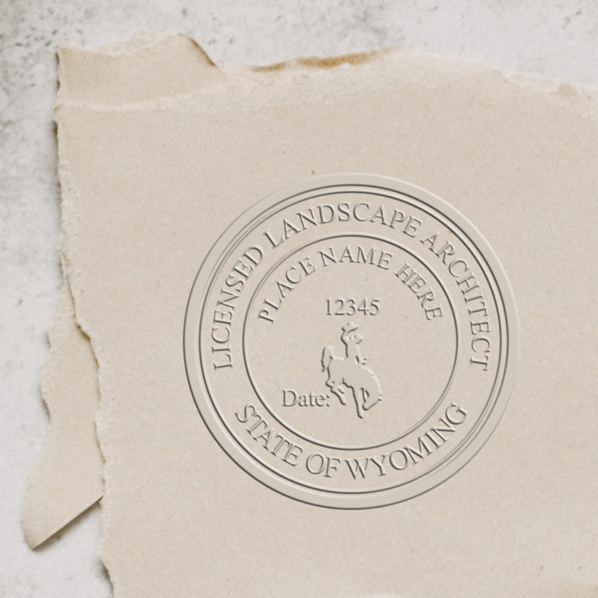 An in use photo of the Hybrid Wyoming Landscape Architect Seal showing a sample imprint on a cardstock
